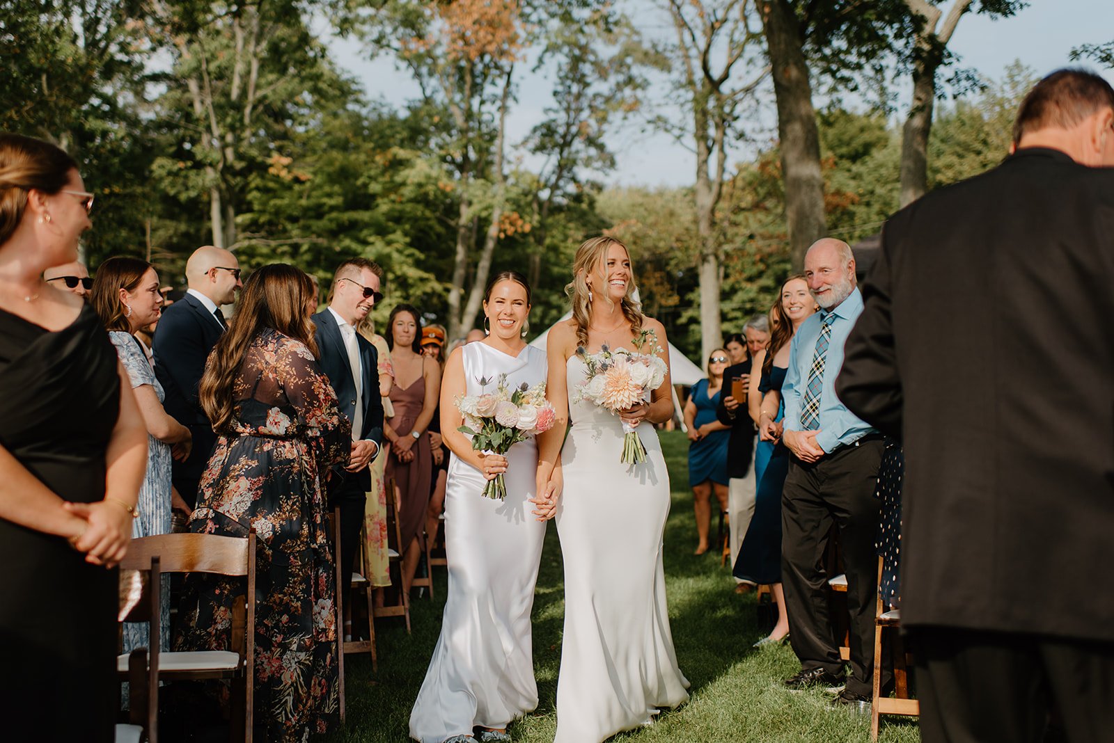 Family Home Kingston Wedding of Vanessa and Liz – Vanessa and Liz walking down the aisle hand in hand during their heartfelt bridal march
