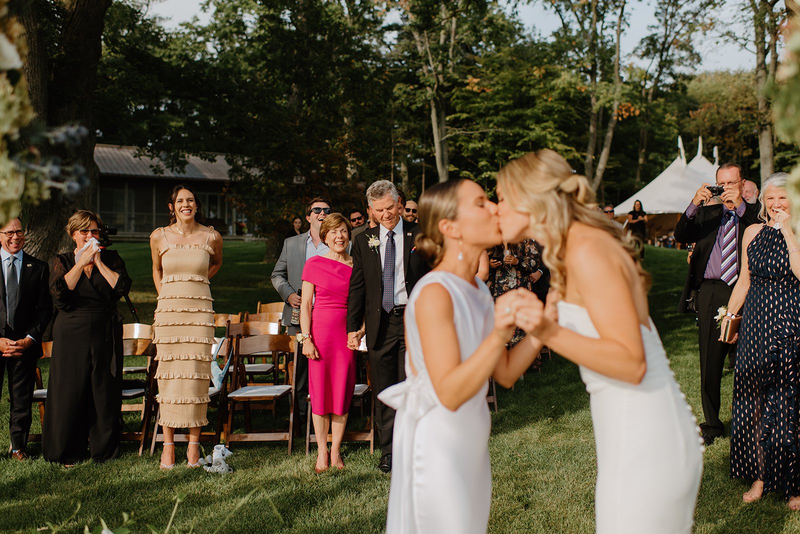 Family Home Kingston Wedding of Vanessa and Liz – joyful exit from the wedding ceremony as Vanessa and Liz walk back up the aisle, smiling and hand in hand