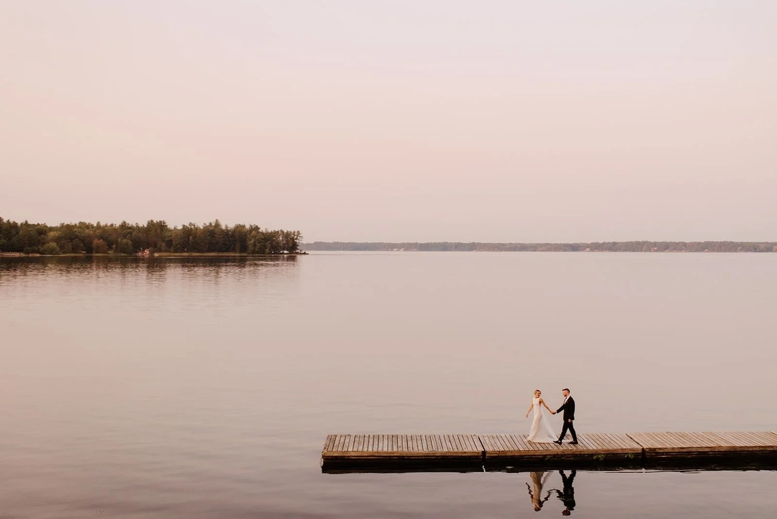 Joyful Bayview Wildwood Wedding – The couple walking along the beach.