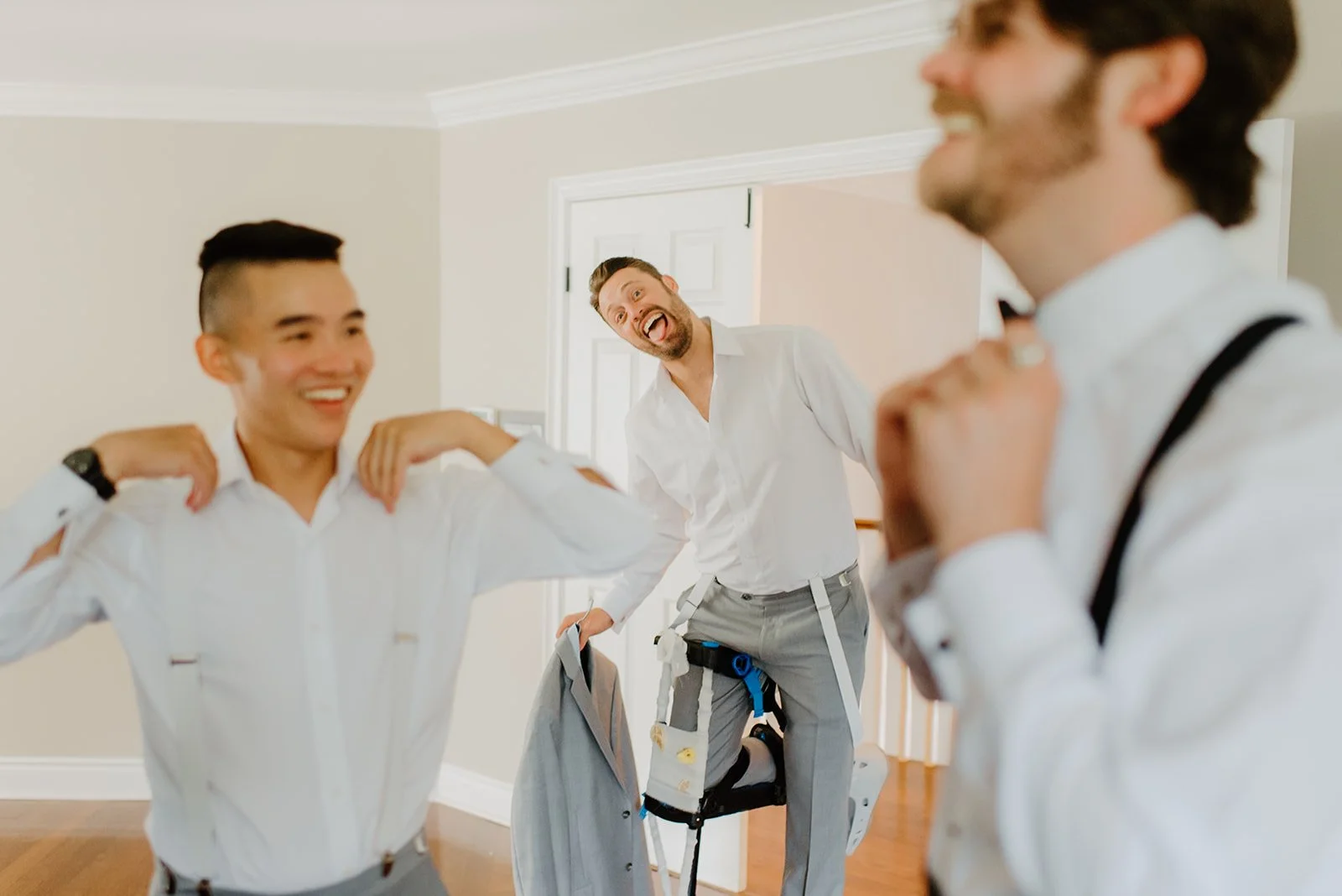 Eaton Hall Wedding in King City | Benita + Allen – Allen adjusting his tie in a mirror at a sun-drenched Airbnb.