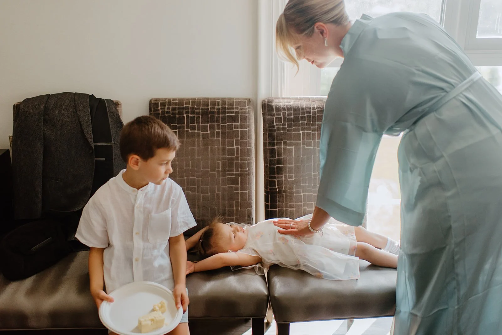 Eaton Hall Wedding in King City | Benita + Allen – A quiet candid moment as children rest indoors while a family member gently checks on them during the wedding day.