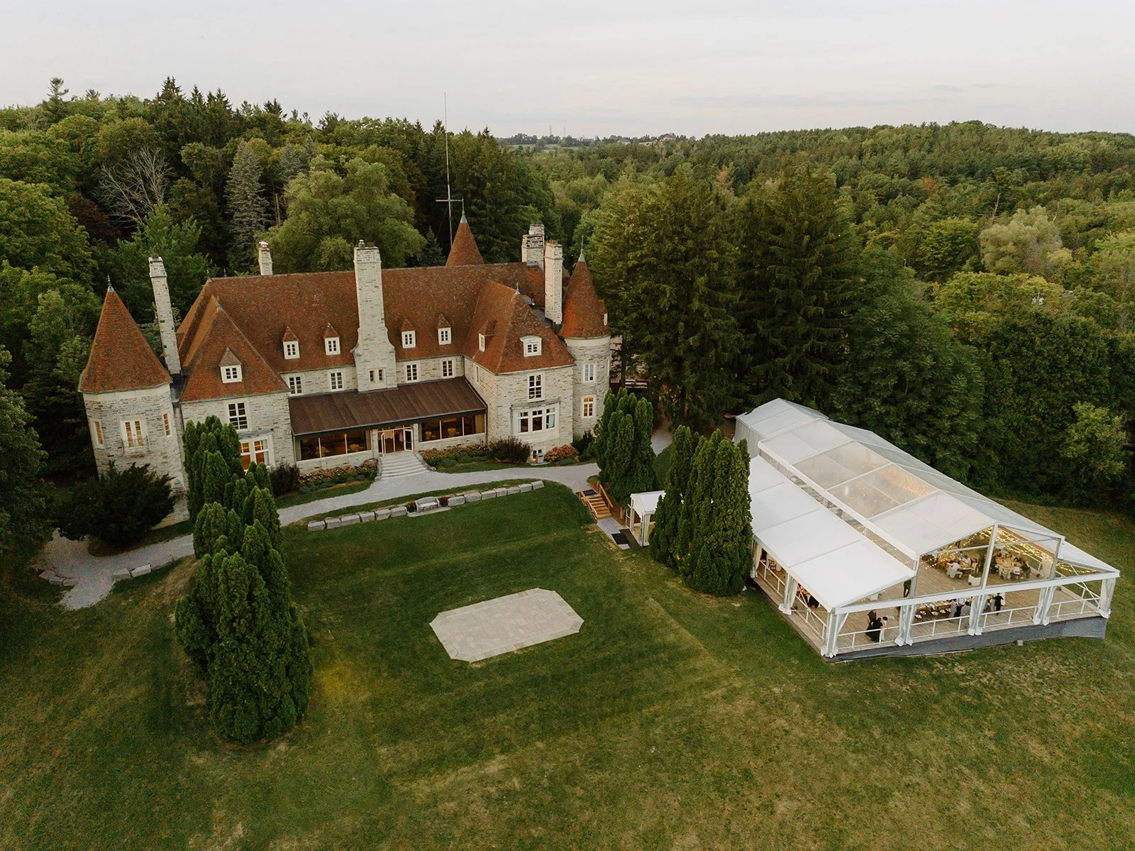 Eaton Hall Wedding in King City | Benita + Allen – The historic stone architecture of Eaton Hall framed by summer trees.