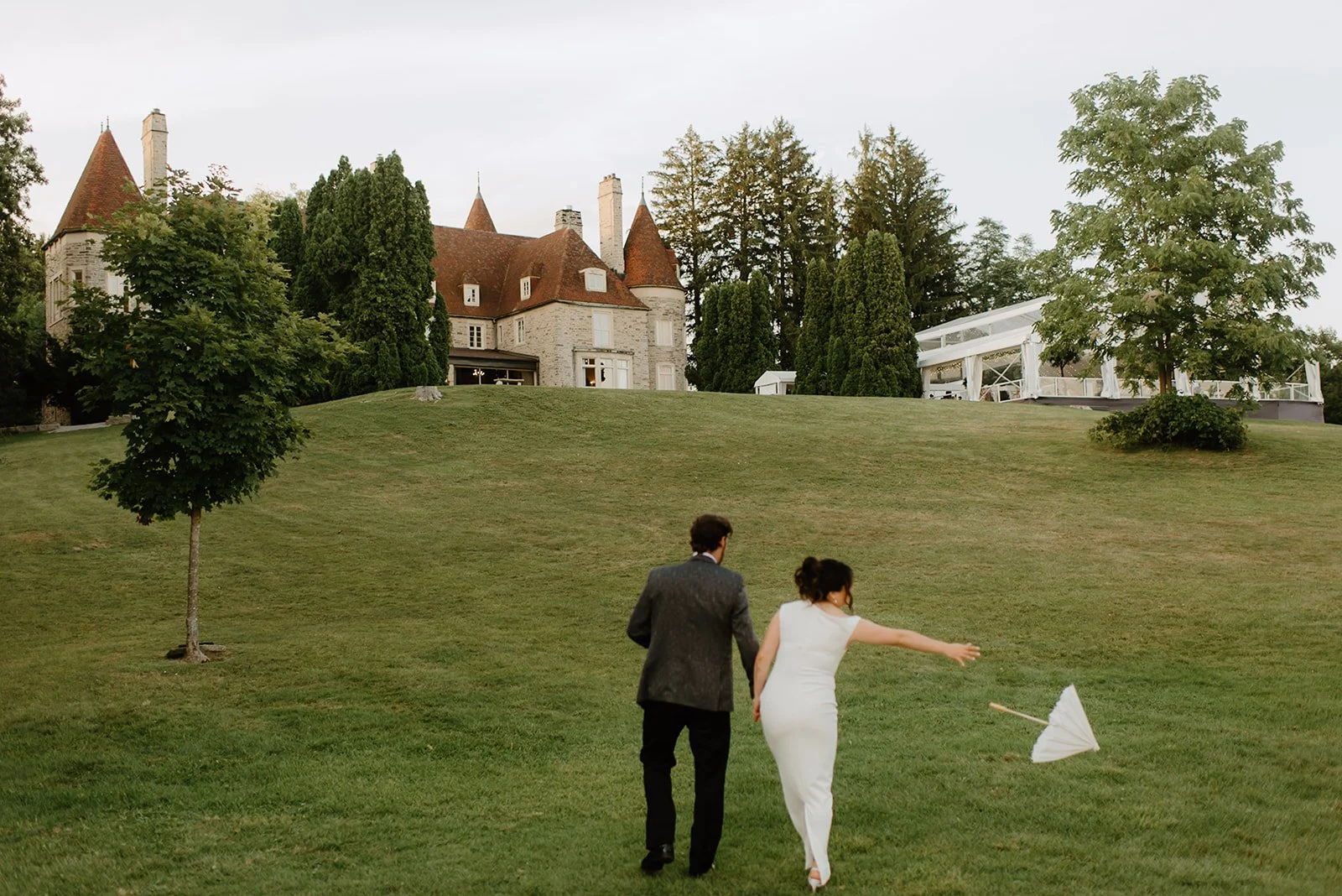 Eaton Hall Wedding in King City | Benita + Allen – Benita and Allen walking through a path of greenery hand-in-hand.