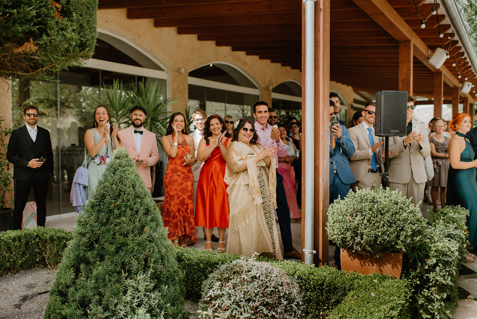 Castell de Barxell Wedding | A Romantic Spanish Countryside Celebration with Zuzanna + Raul – Joyful candid of guests cheering.