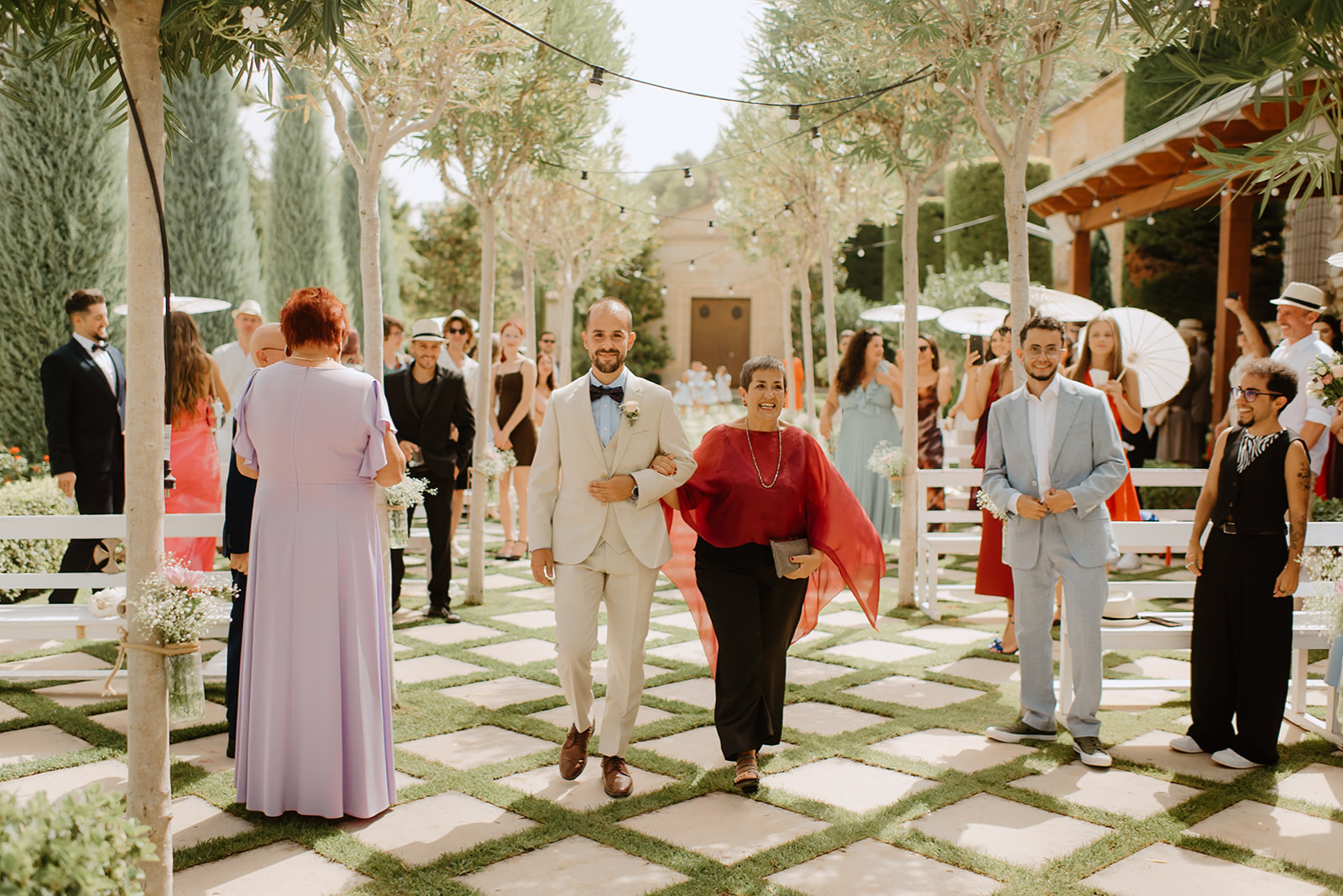 Castell de Barxell Wedding | A Romantic Spanish Countryside Celebration with Zuzanna + Raul – The stone pathway leading to the ceremony site lined with trees.