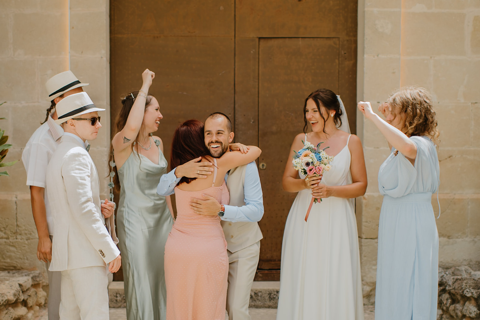 Castell de Barxell Wedding | A Romantic Spanish Countryside Celebration with Zuzanna + Raul – Guests mingling in the sun-drenched courtyard of Castell de Barxell.