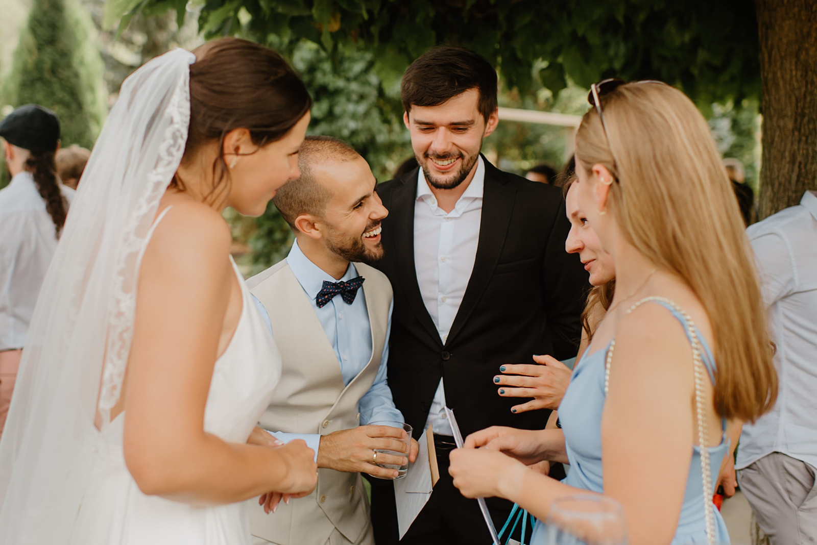 Castell de Barxell Wedding | A Romantic Spanish Countryside Celebration with Zuzanna + Raul – Guests mingling in the sun-drenched courtyard of Castell de Barxell.
