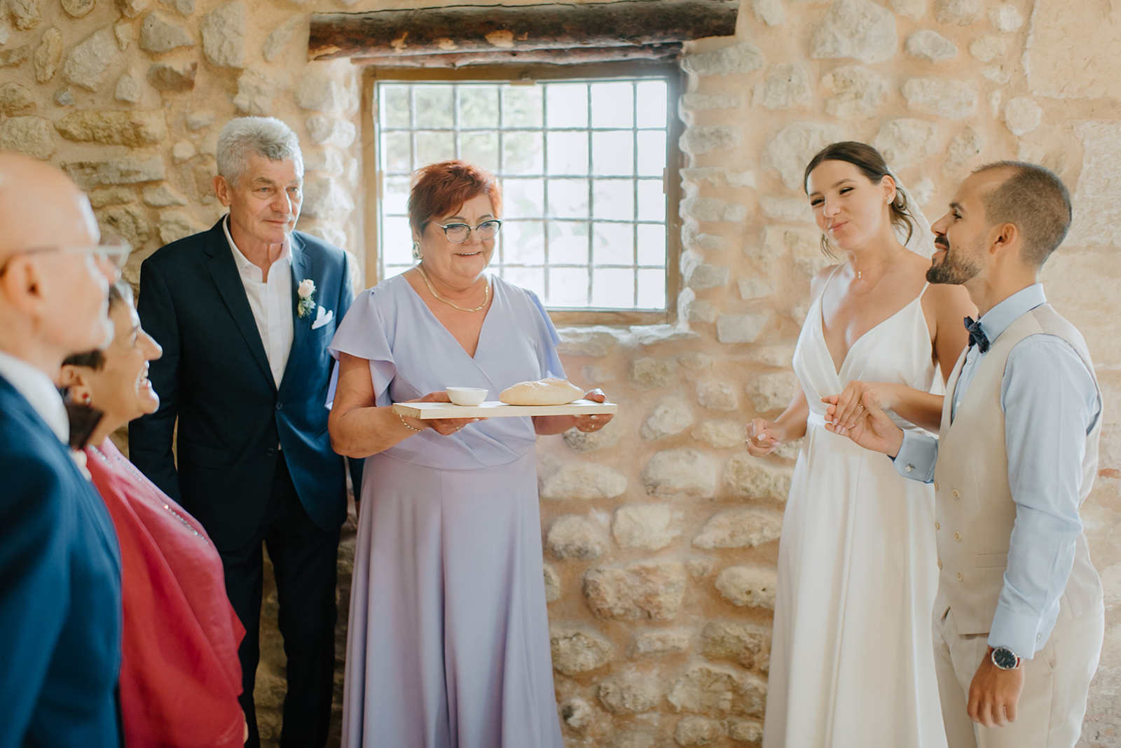 Castell de Barxell Wedding | A Romantic Spanish Countryside Celebration with Zuzanna + Raul – Guests mingling in the sun-drenched courtyard of Castell de Barxell.