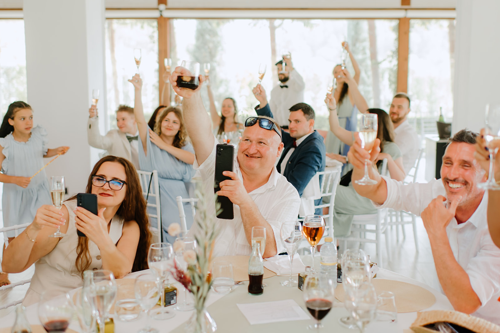 Castell de Barxell Wedding | A Romantic Spanish Countryside Celebration with Zuzanna + Raul – Guests clinking glasses during a celebratory toast.