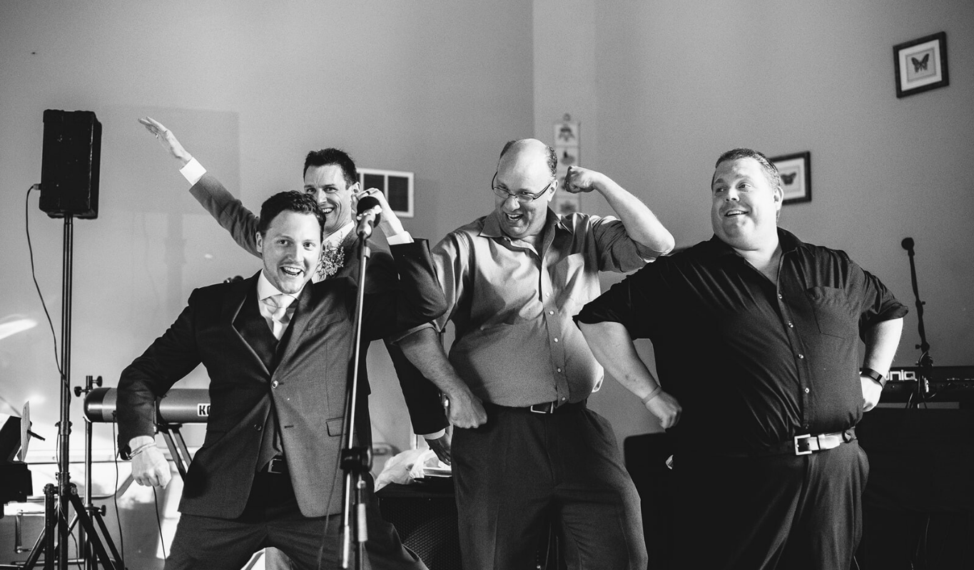Guests performing an acapella song during a wedding reception.