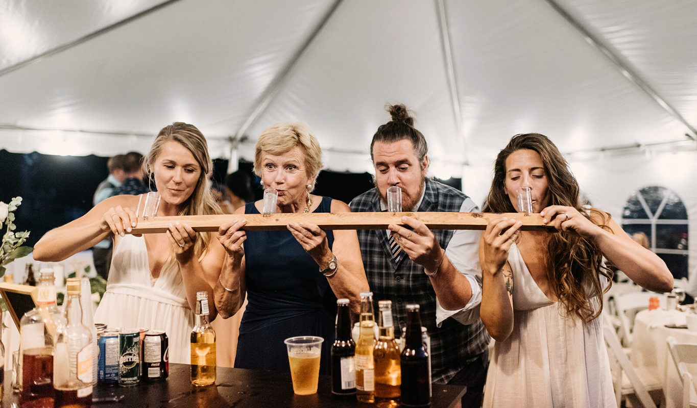 Guests taking a fun ski shot together at a wedding reception.