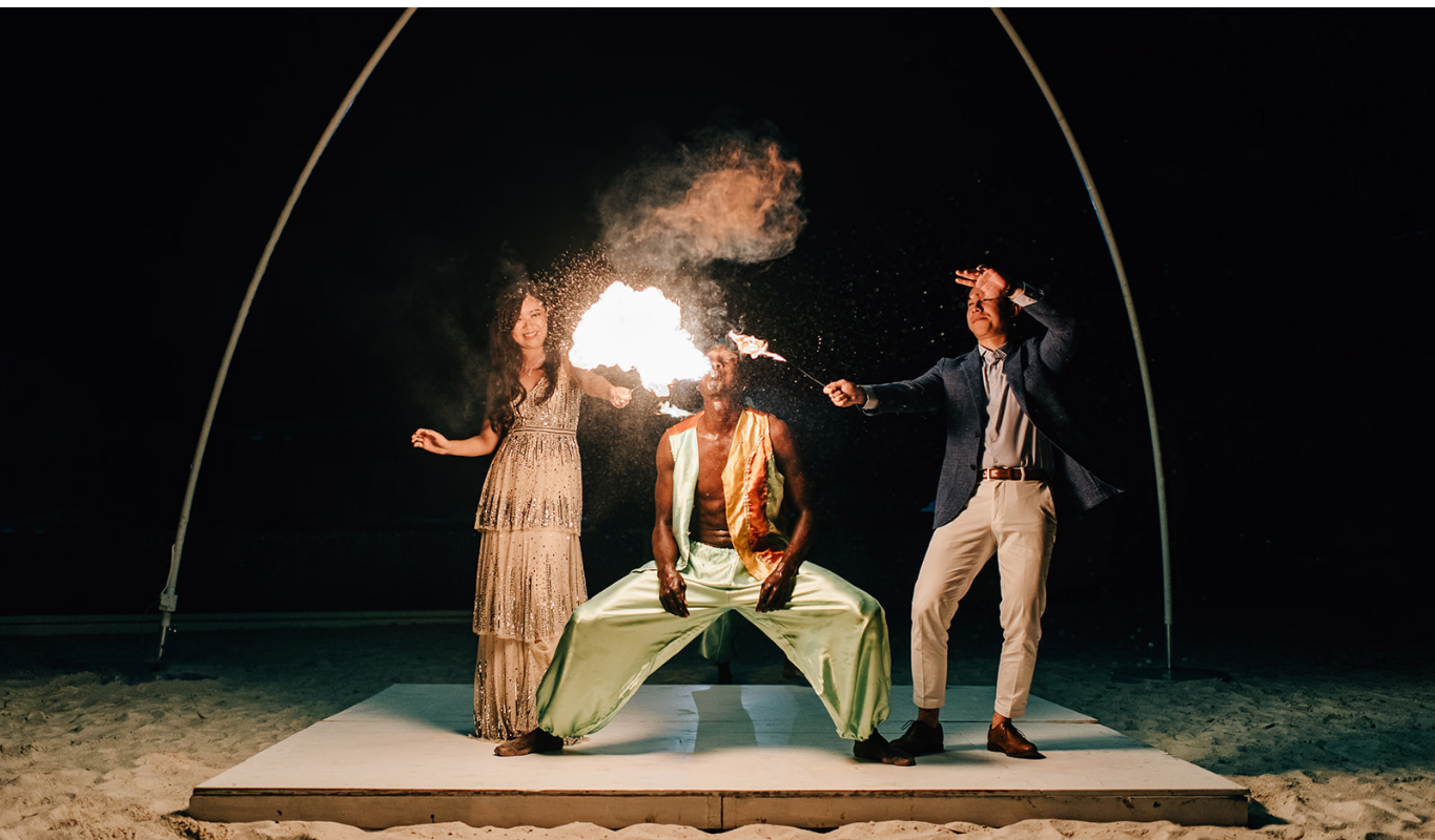Fire dancer performing at a wedding reception, lighting up the night with flames.