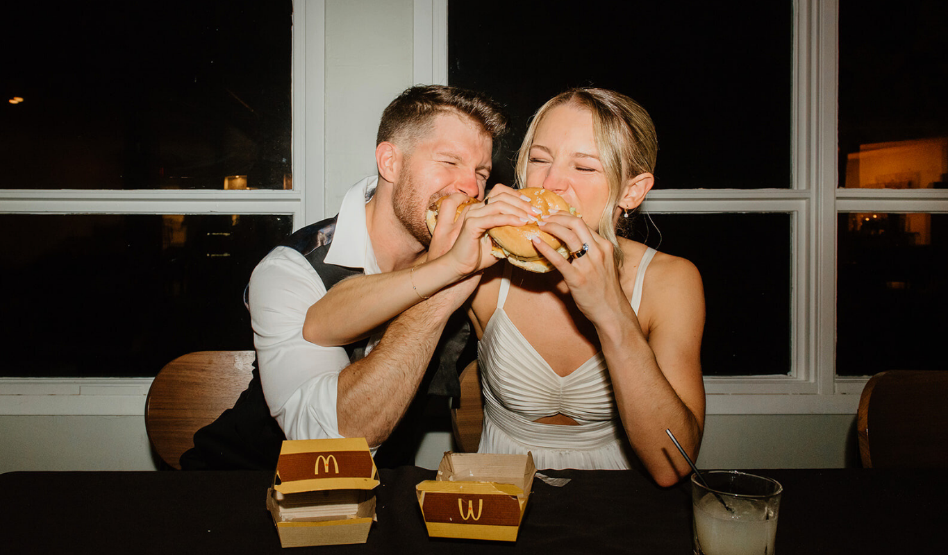 Couple enjoying a late-night McDonald’s meal at a wedding reception.