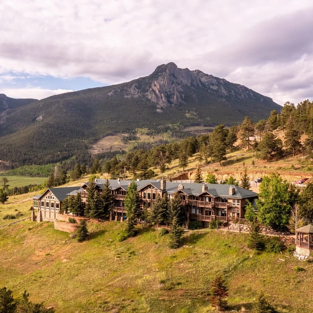 An aerial view of Taharaa Mountain Lodge and the rows of hills and mountains that surround it.