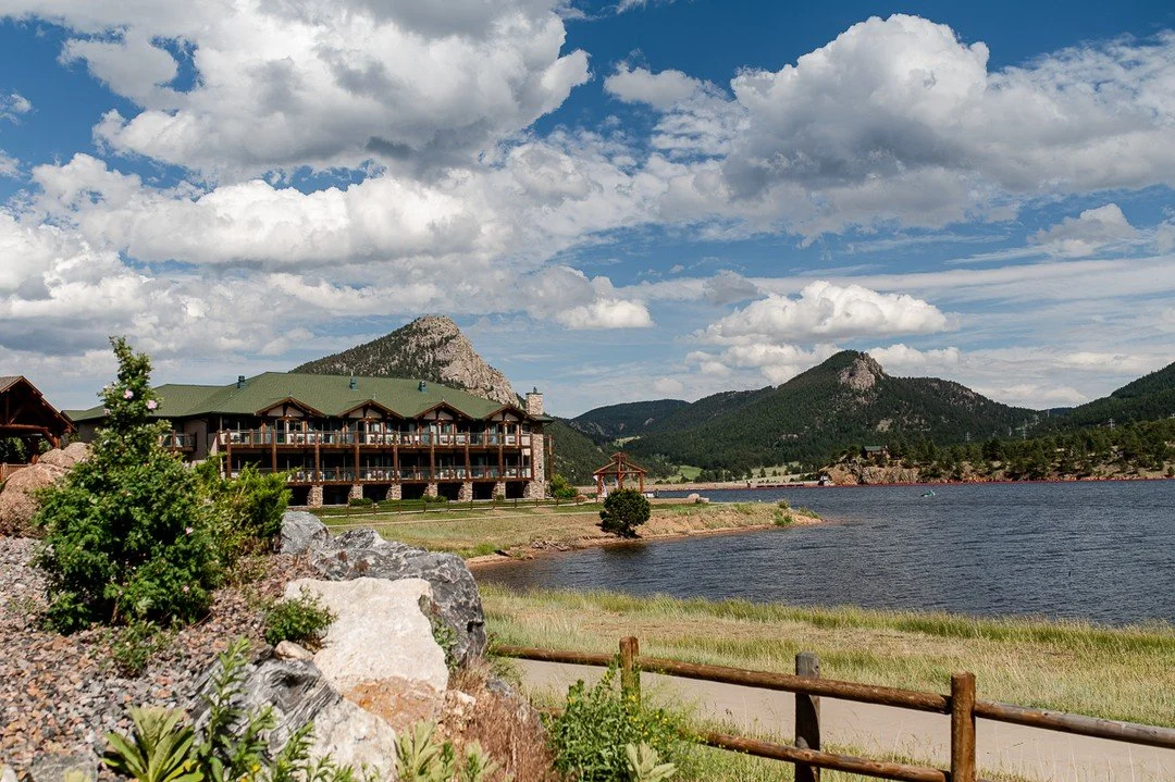 The view of the Estes Park Resort from the walkway that leads to it, complete with the lake and mountains that surround the resort.