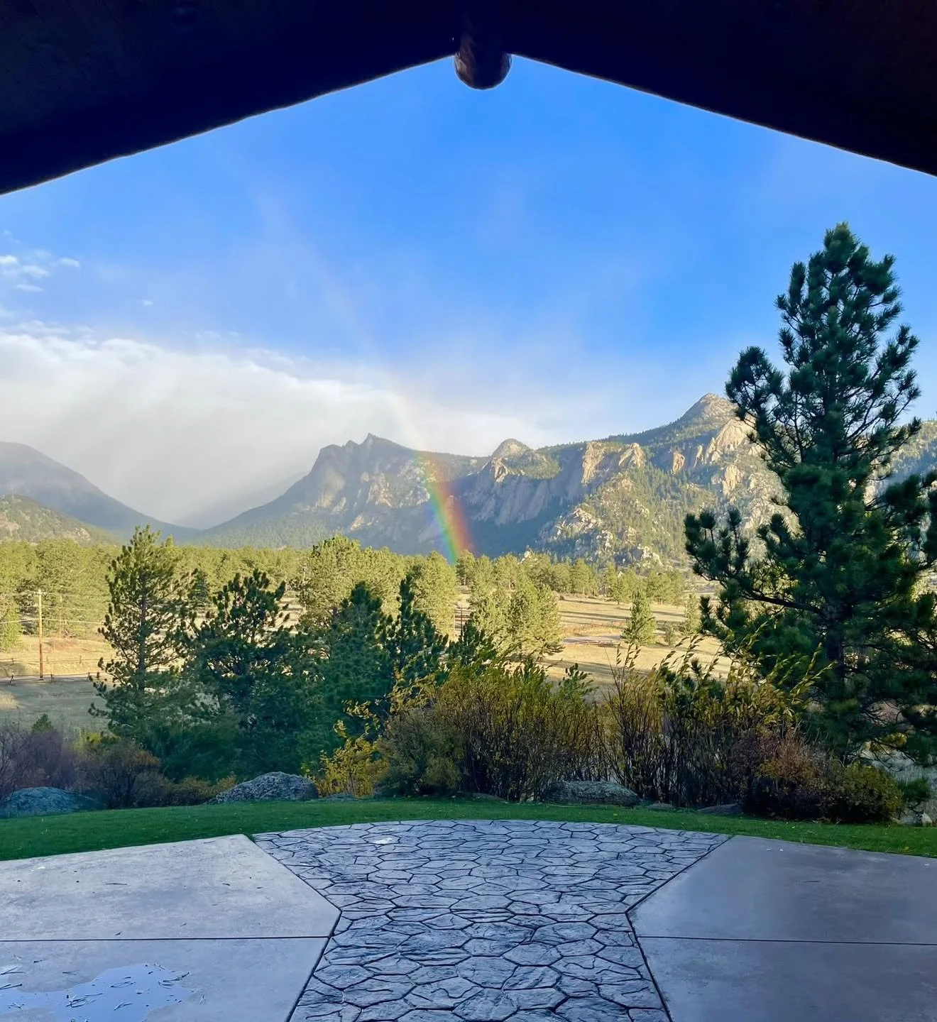 The mountain view complete with a perfect rainbow right down the middle of the stone Homestead space.