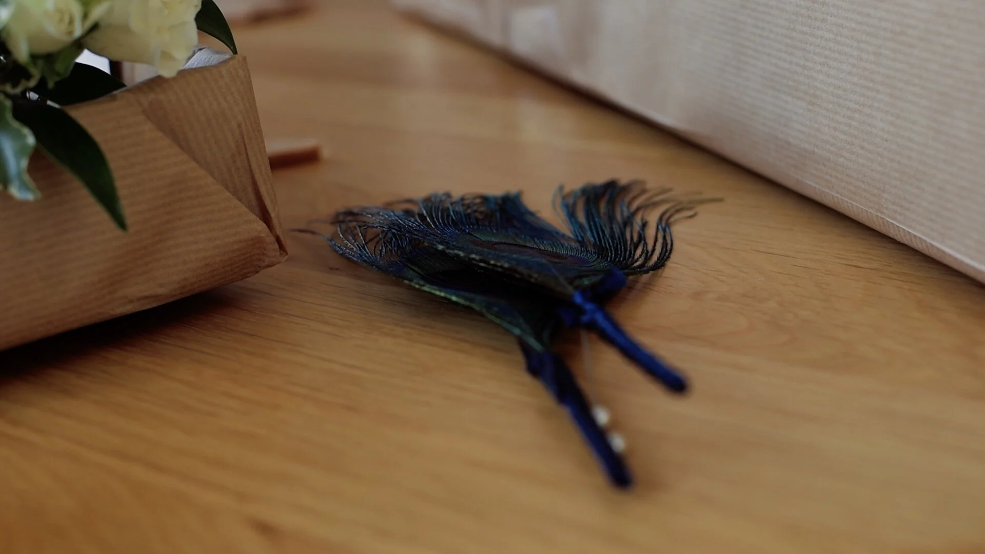 An image of the peacock feather buttonholes that were produced for the groomsmen by ‘Blue Door Flowers’