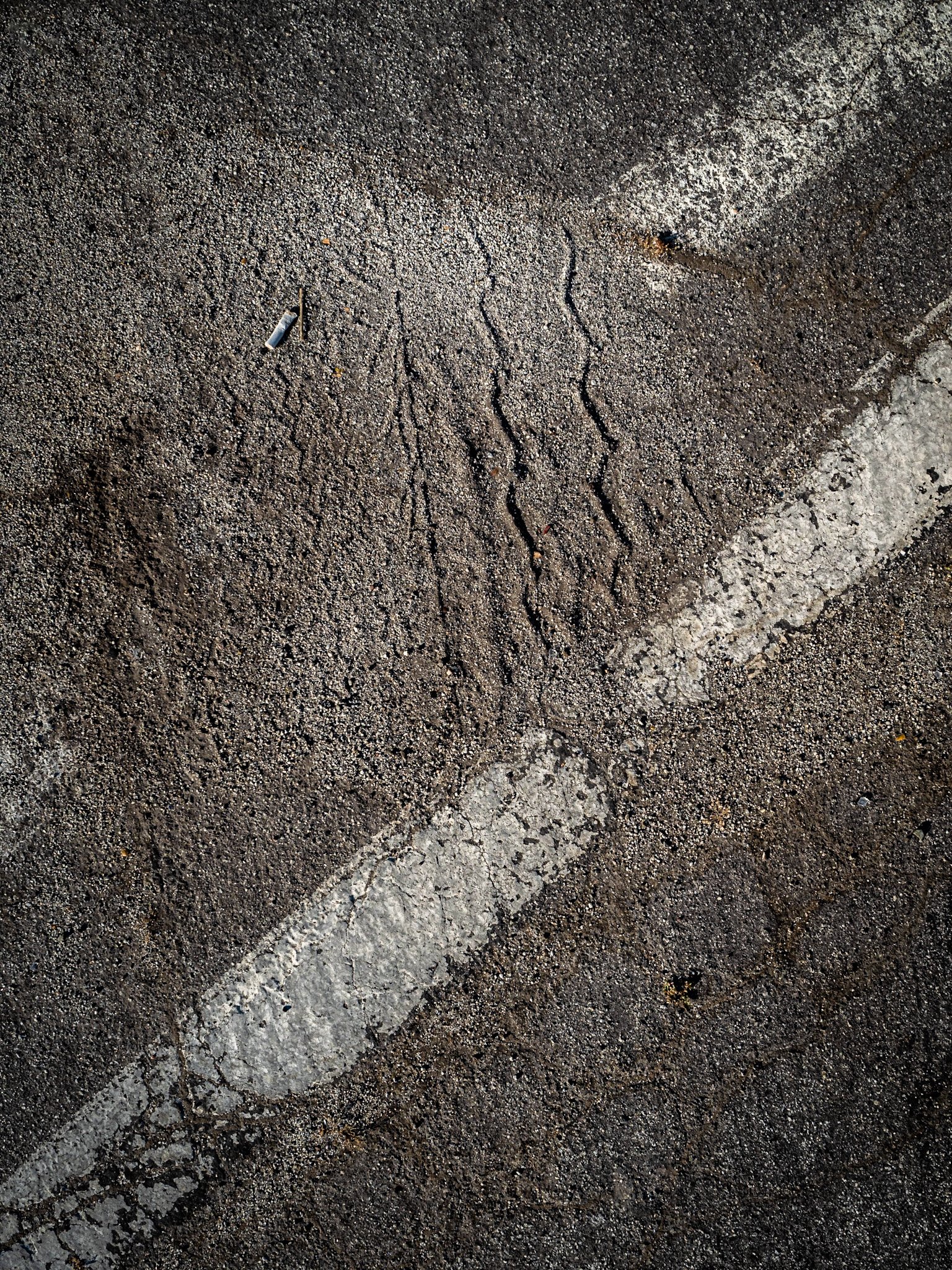 Composition with Diagonals, Dirt, and Cigarette Butt