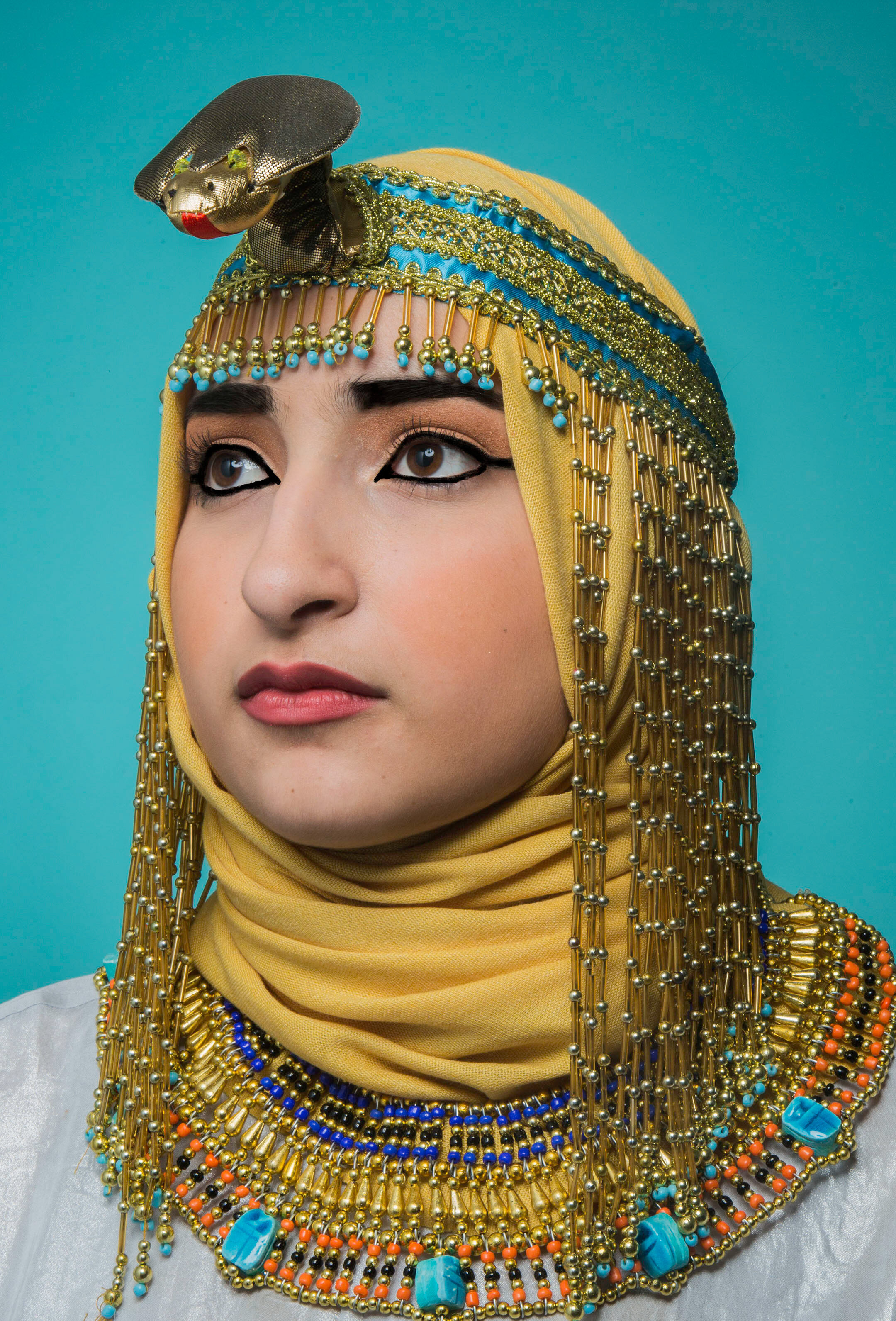 A woman dressed as Cleopatra wearing a hijab.