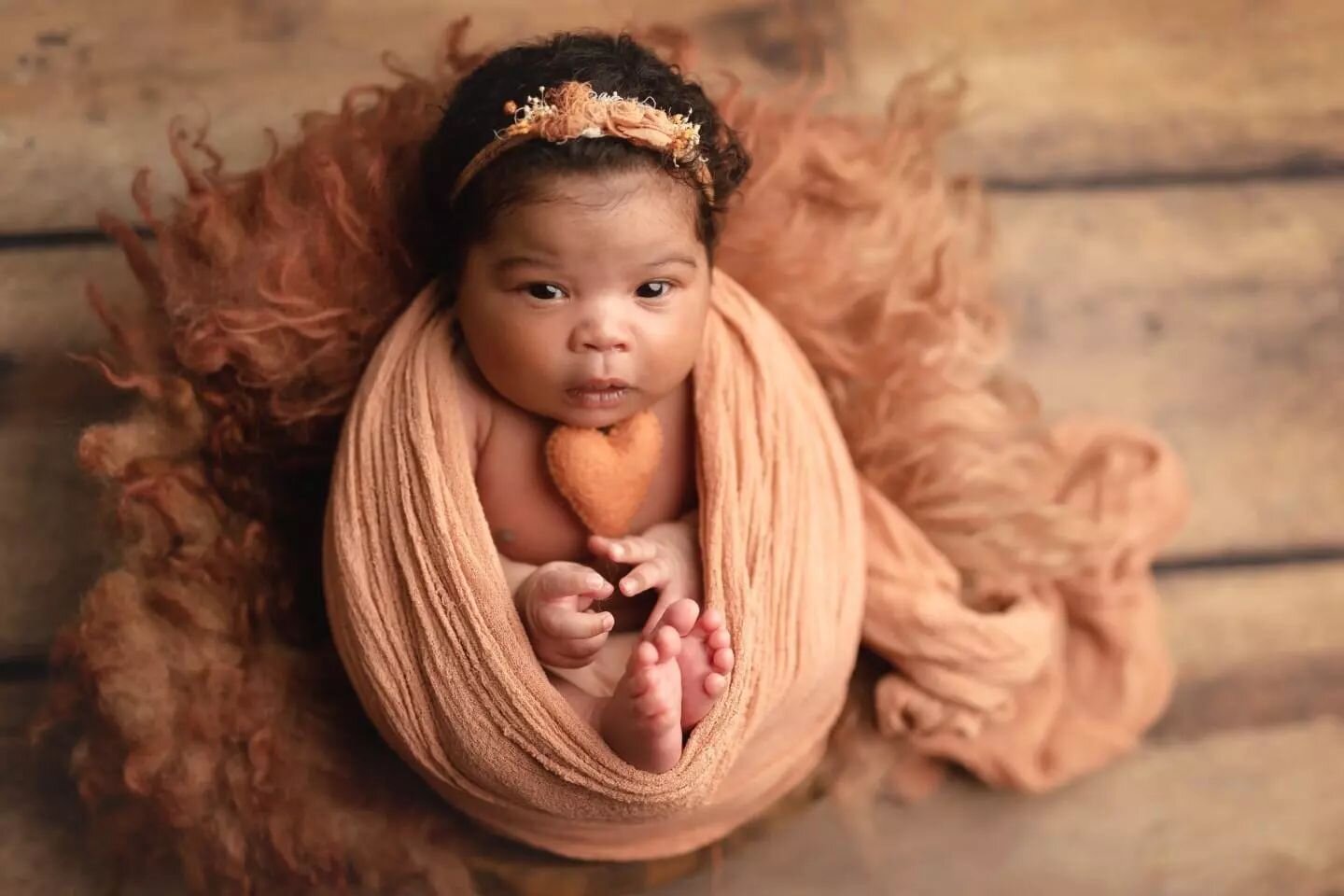 I think the true magic of newborn photography happens right behind the scenes, when posing and soothing the baby.

There's a wide variety of newborn poses. From a sweet swaddle to a baby in a basket, each one of them is so adorable and meant to keep 