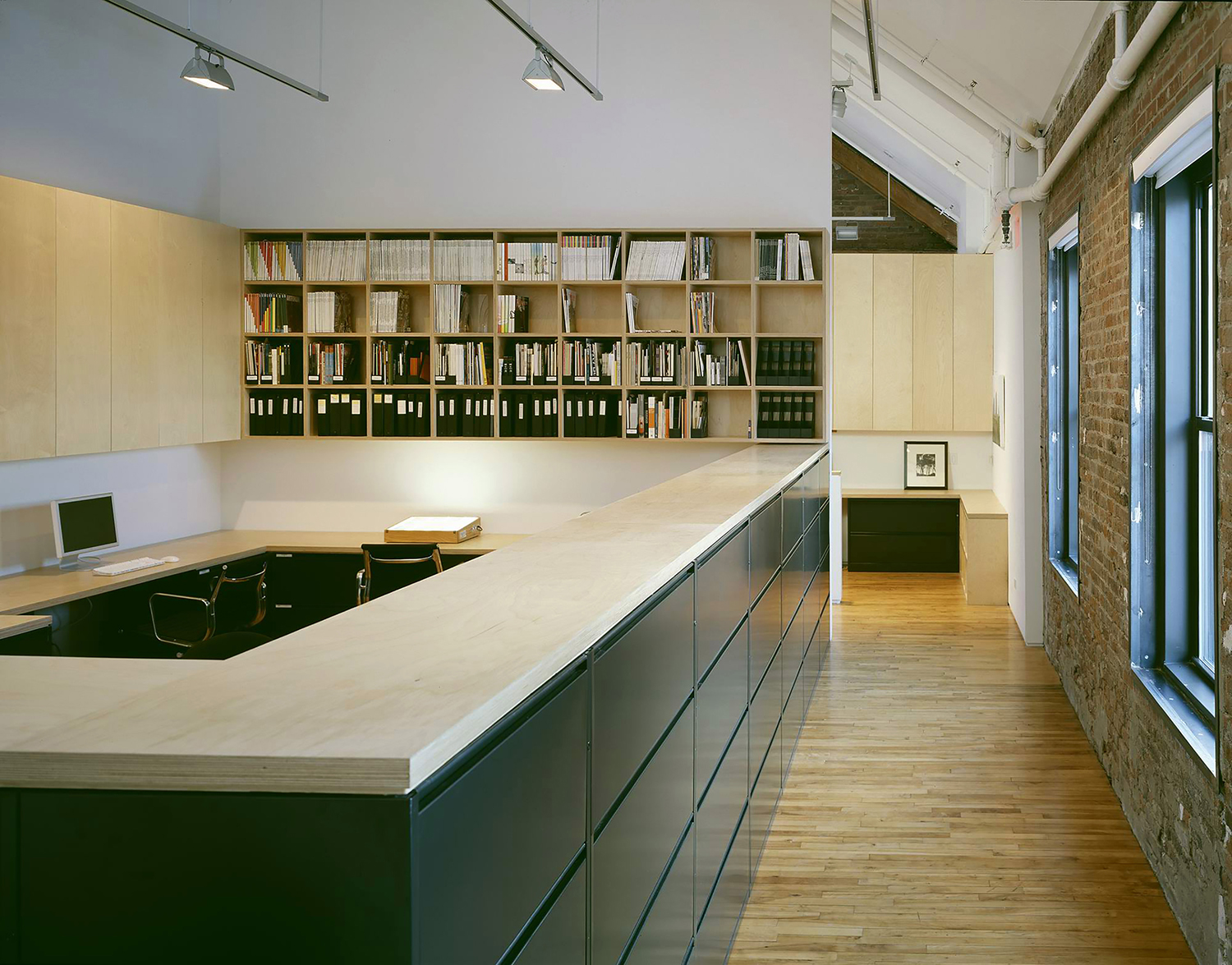 Clean lines, purposefully designed built-in storage, a mono-chromatic color scheme and natural light make workspaces calm and uplifting.