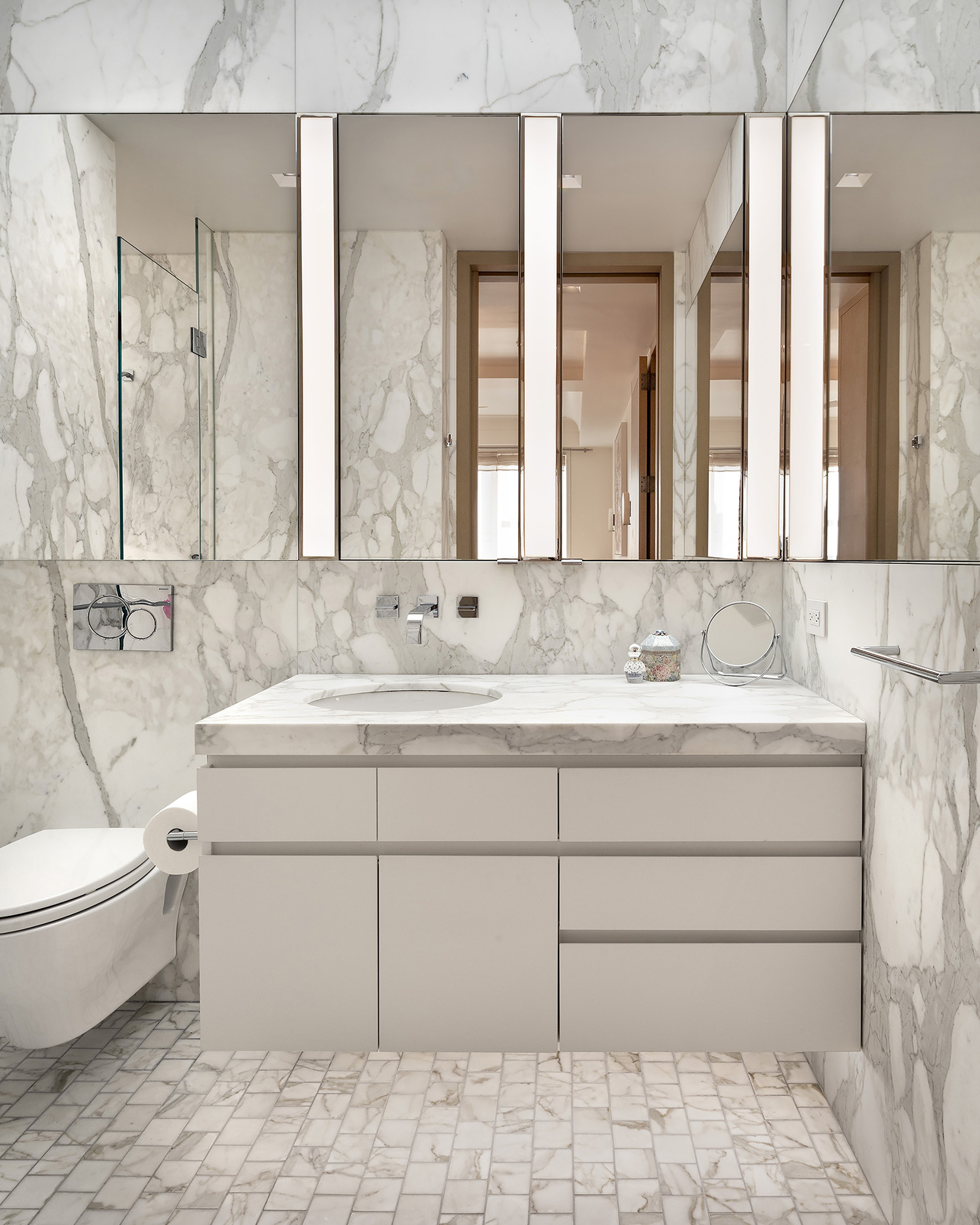 While retaining the use of classical materials, the modern sensibility so evident in the main rooms runs throughout the apartment, all the way down to the details.
