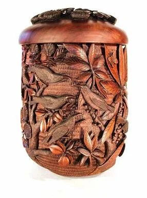Artist Scott Hare's milo calabash "Are We Next," depicts a group of 'i'iwi (the Scarlet Hawaiian honeycreeper, Drepanis coccinea) birds gathered around the last remaining mamo (the Black Hawaiian honeycreeper, Drepanis pacifica) in existence. "They are asking, 'Are we next?'" explains Hare. "The mamo is now extinct, and the 'i'iwi may follow if we are not careful." Photo courtesy: Scott Hare