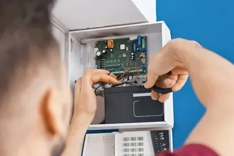 Expert installing security equipment for small business safety