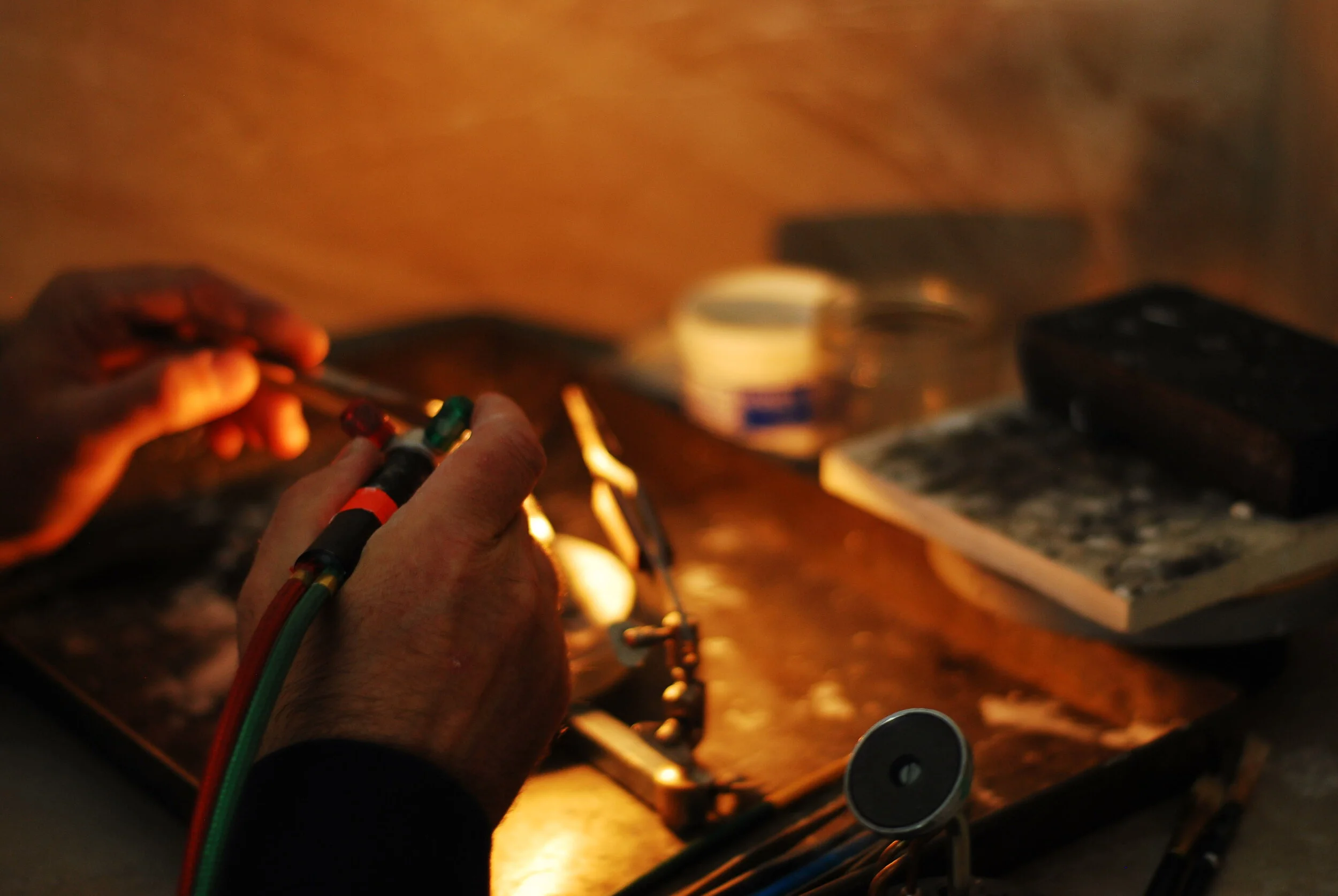 Close-up of hands holding soldering torch  ready to solder a ring
