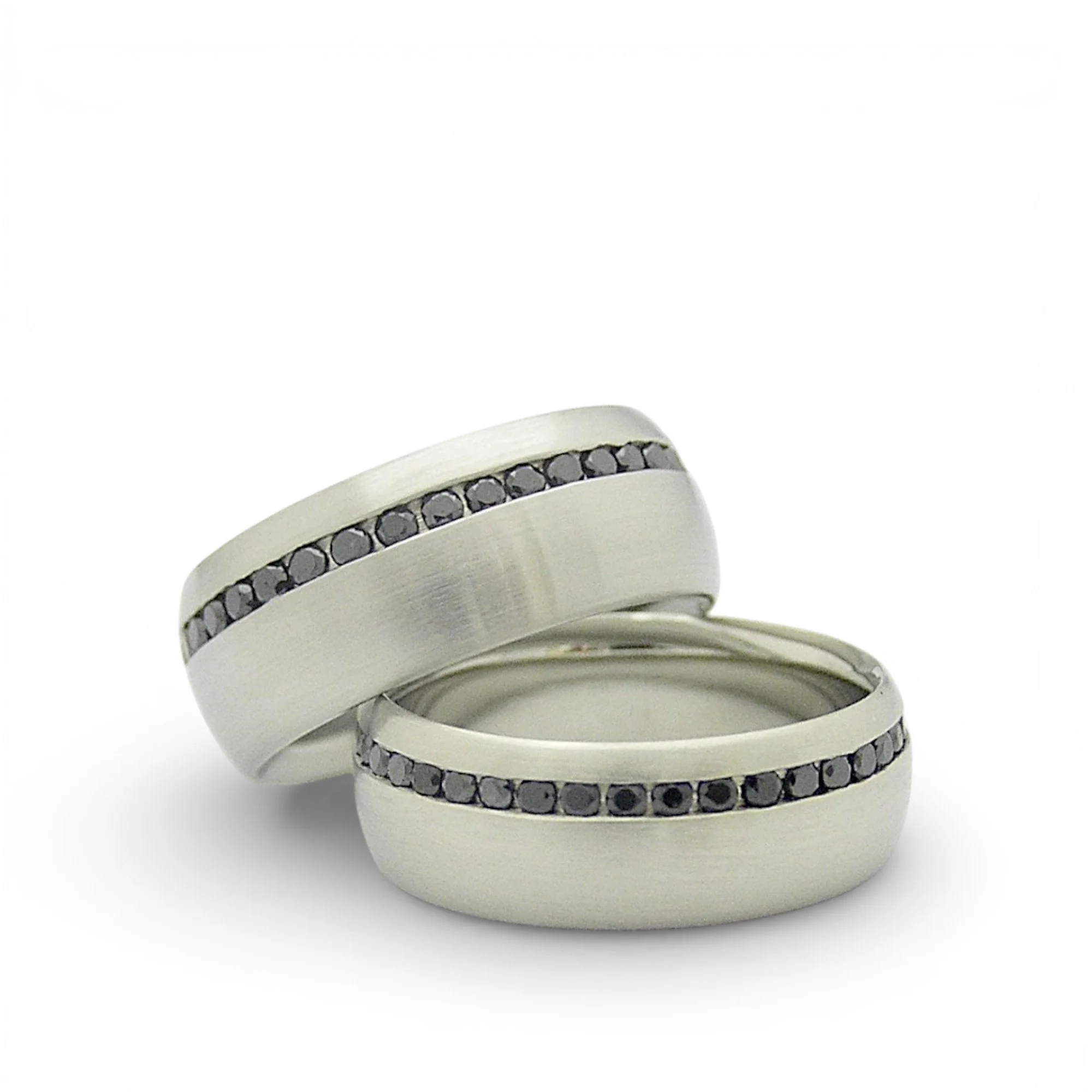 Shallow haf round 10karat white gold rings with channel set black diamonds off centre.jpg