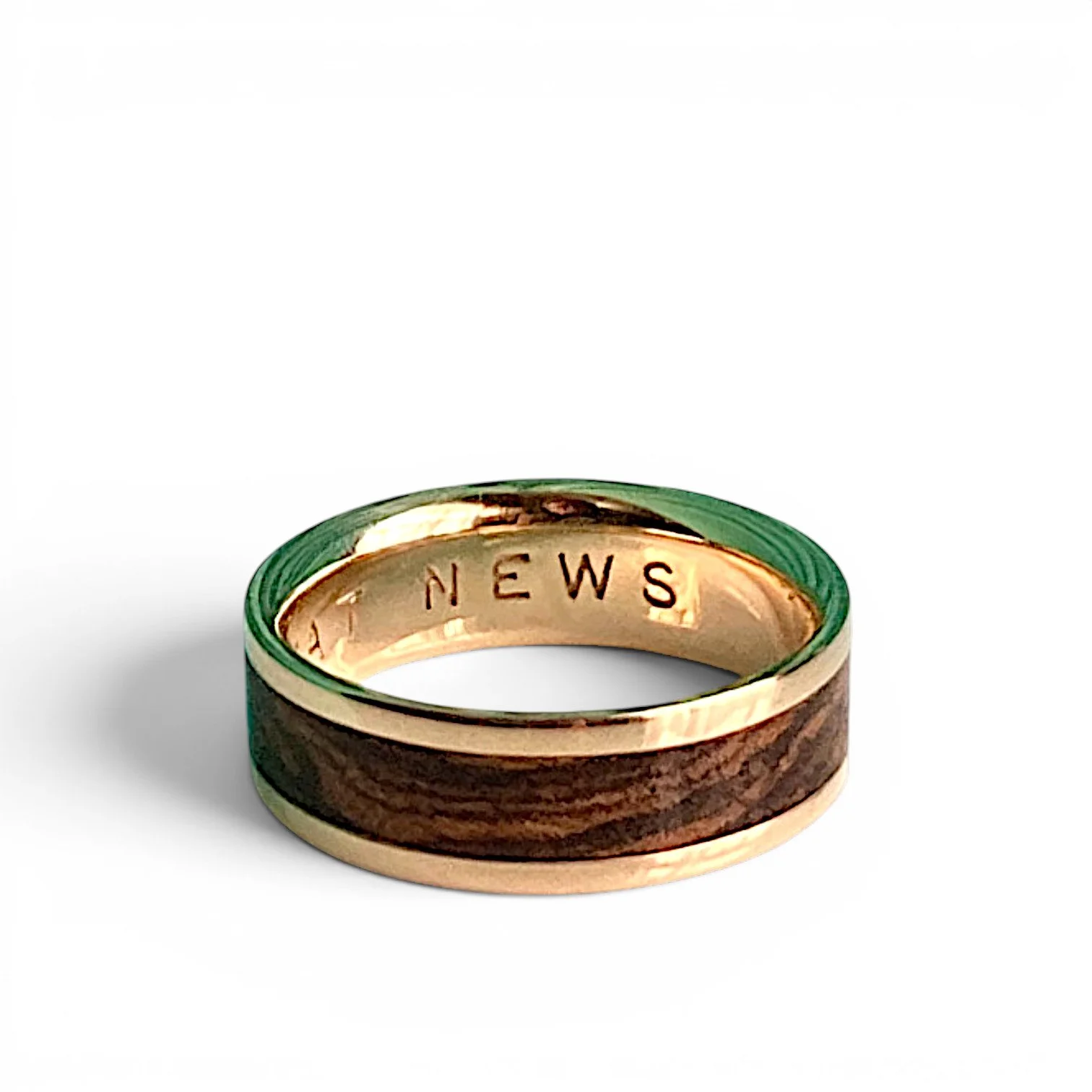Bocote wood in 10karat yellow gold on white background laying flat