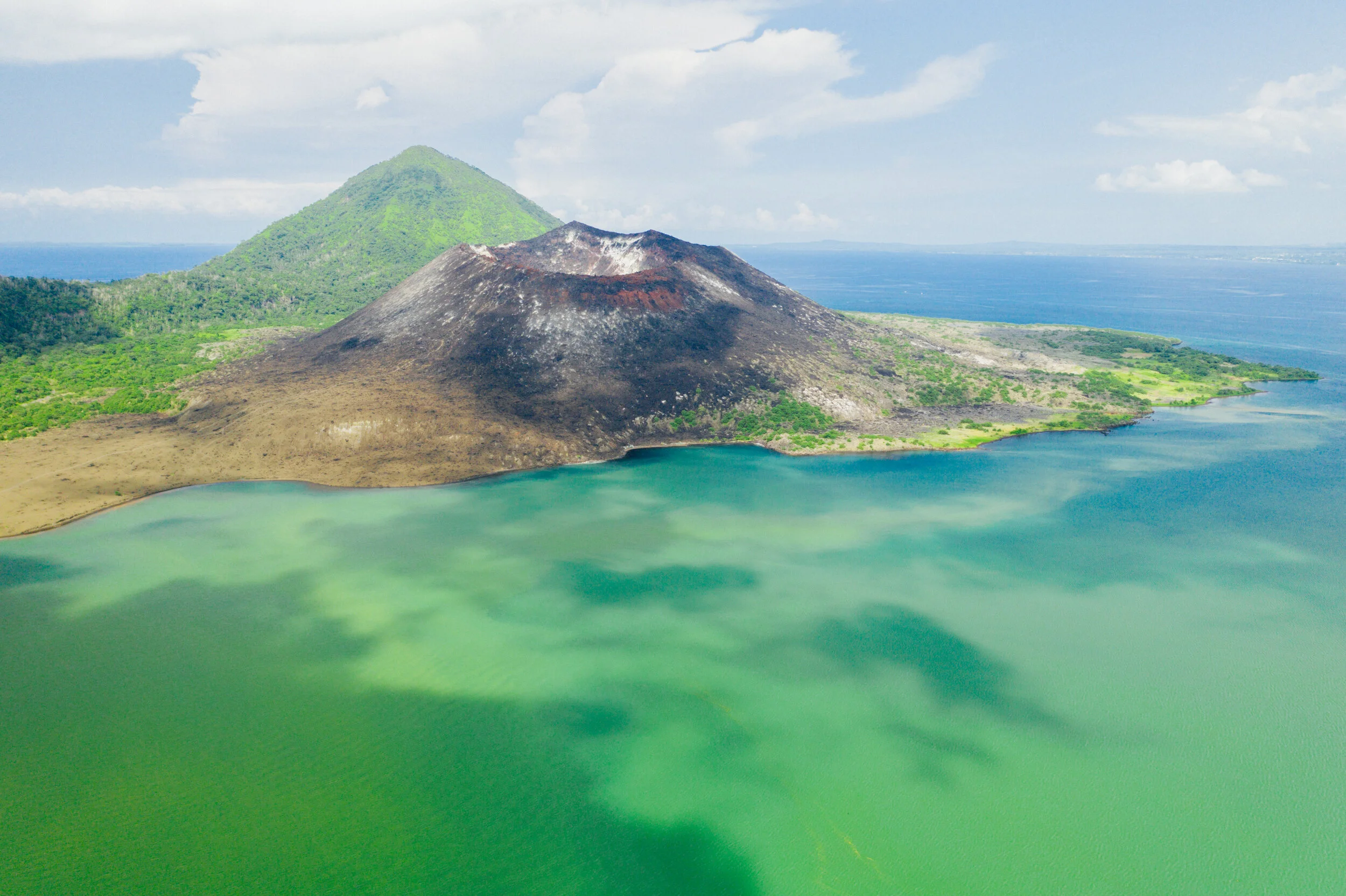 Tavurvur Volcano sits in the emerald green bay near Rabaul, New Britain, Papua New Guinea.
