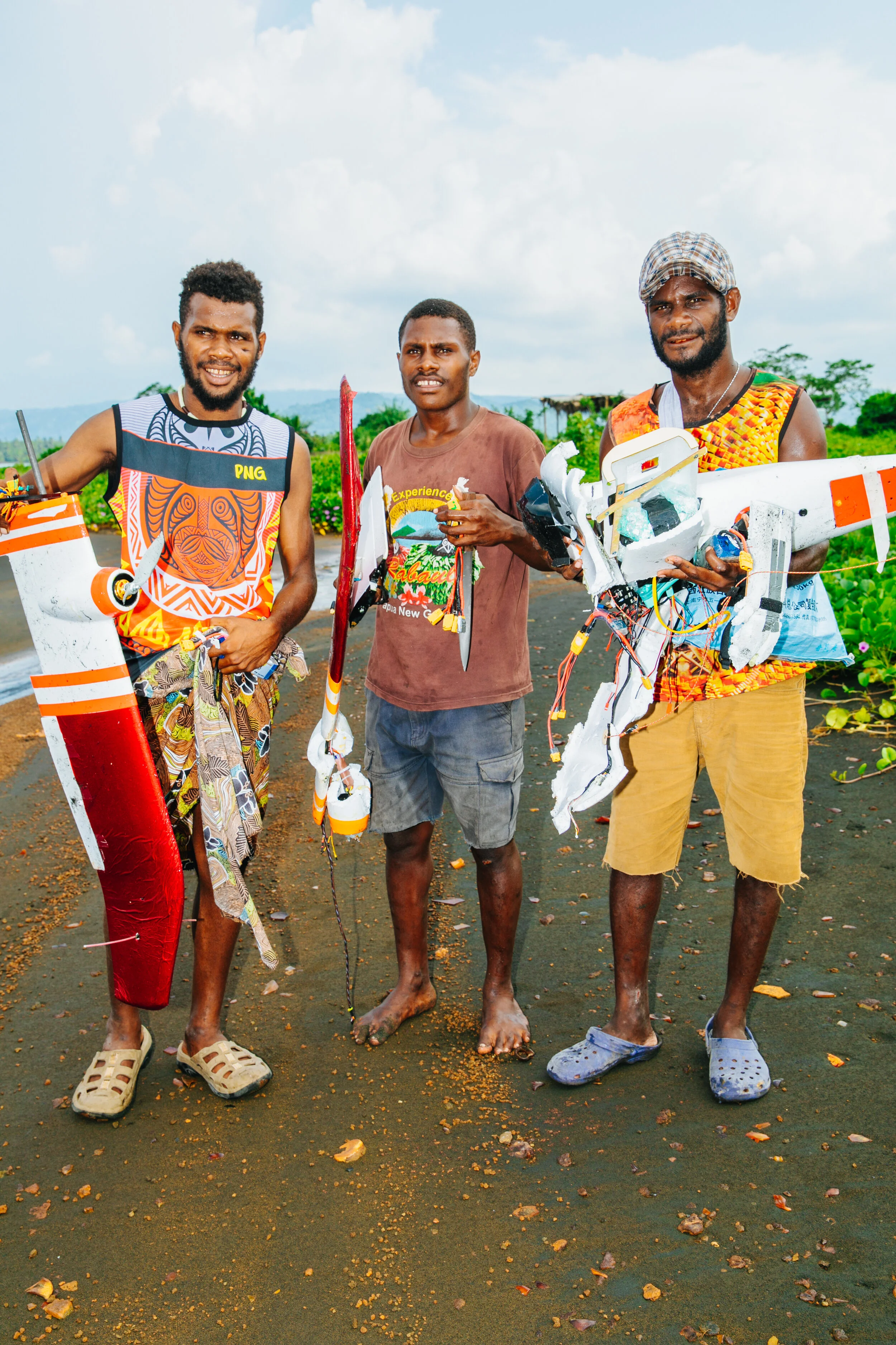 Rabaul locals hold pieces of Titan after a failed flight
