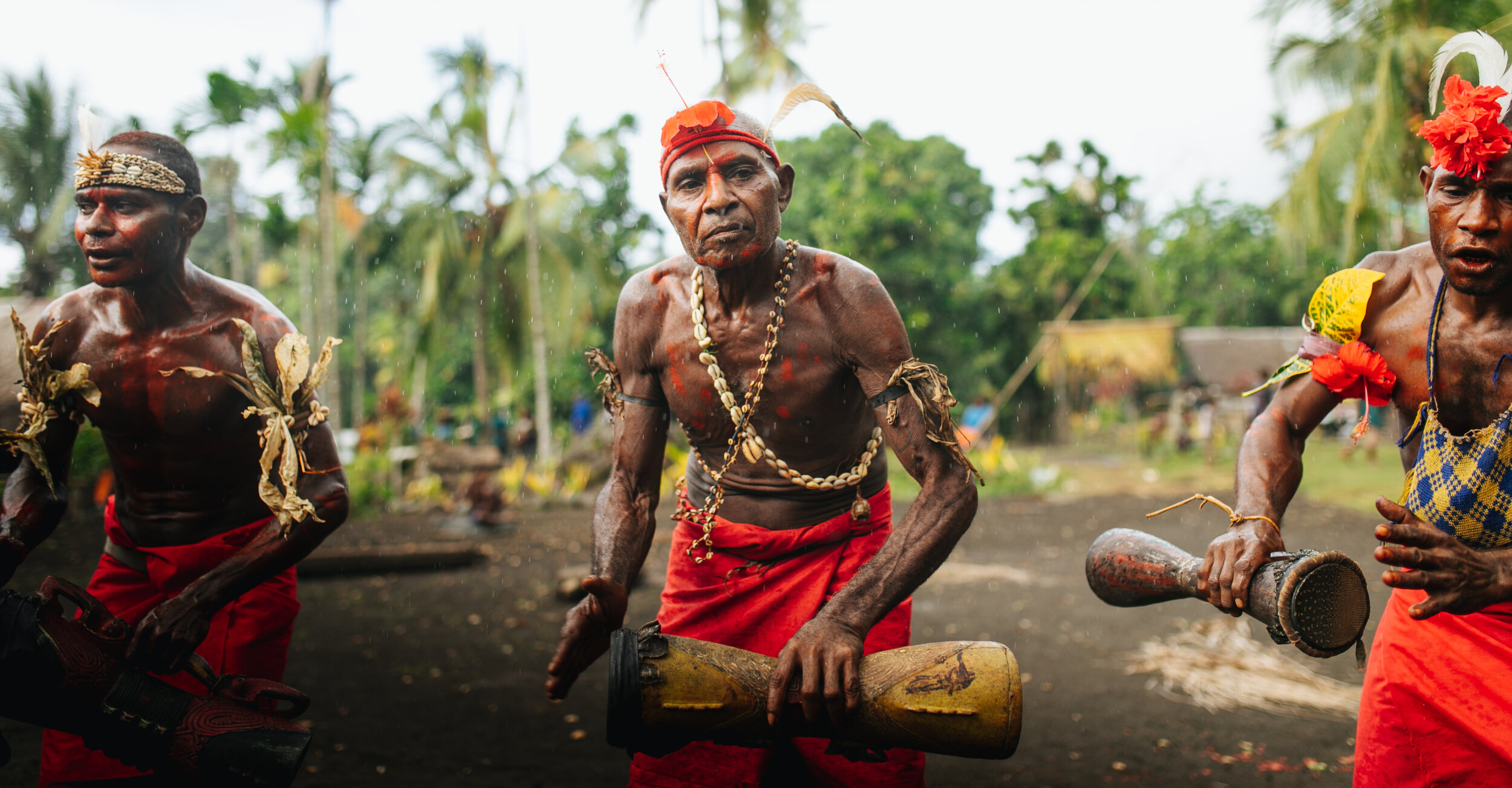 Rain begins to fall during our final day on Manam. Francis and other islanders perform a farewell ceremony.