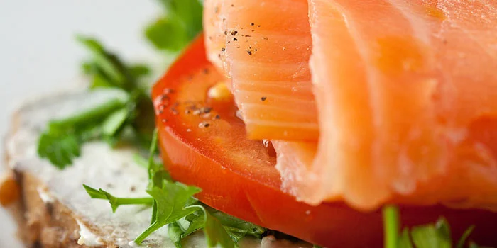Salmon canape with tomato and lettuce