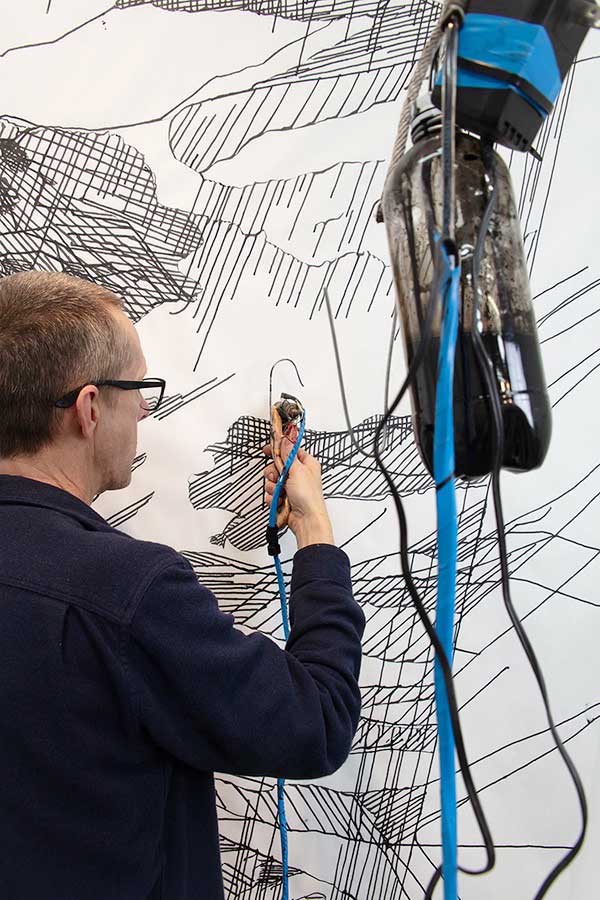 Artist Tim Hawkinson using his gravity-operated hypodermic needle drawing device to create images for the forthcoming 2019 Arion Press edition of Frankenstein