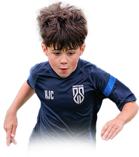 Young boy with curly hair in a navy blue soccer jersey running or sprinting.
