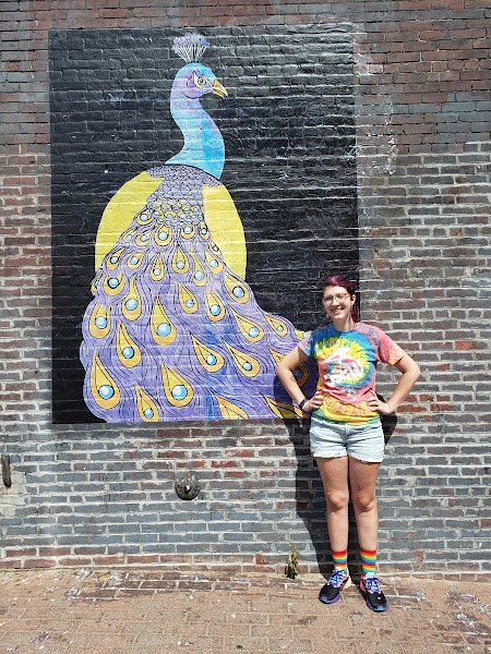 Sam with the "Proud Peacock" wheatpaste mural