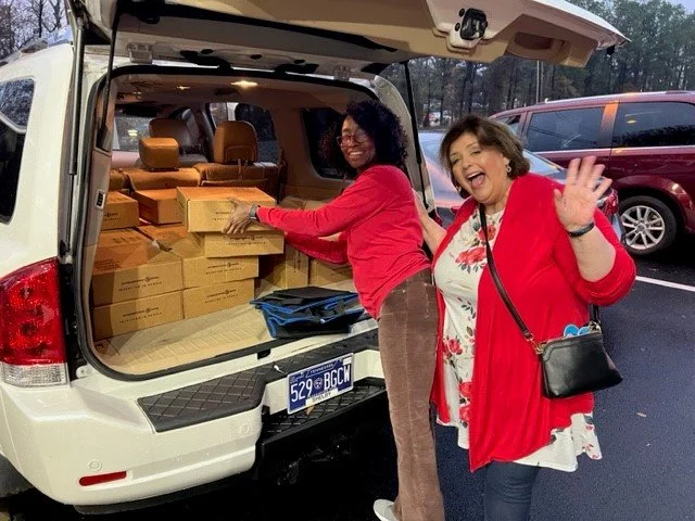 Wuday and volunteer loading car with boxes.jpg