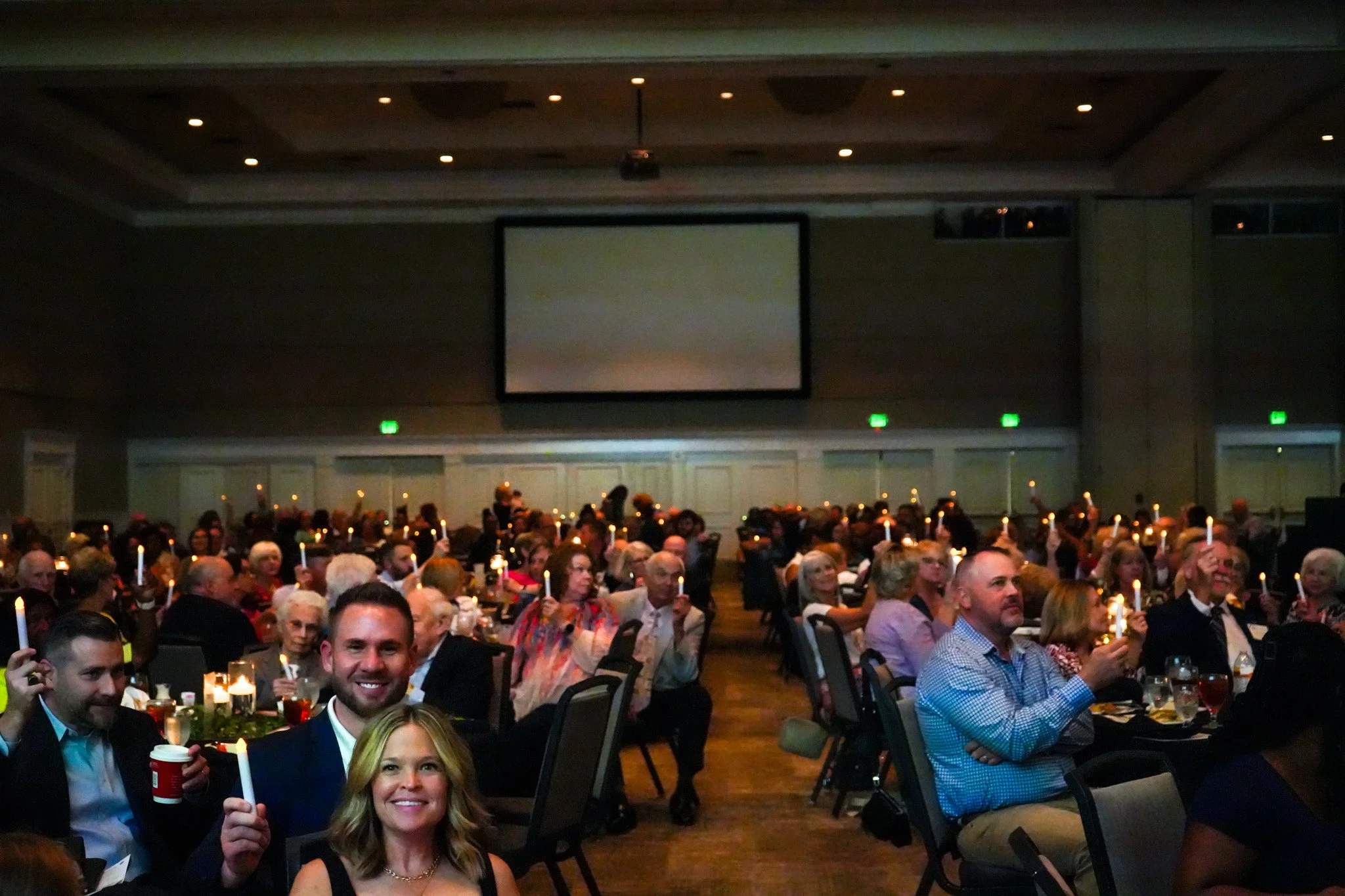 Guests smiling with candles front view.jpg