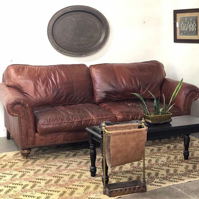 Worn and wonderful with its brass capped feet and nailhead trim, this leather couch is 90&rdquo; wide ( 68&rdquo; between the arms), cozy, and only $585.