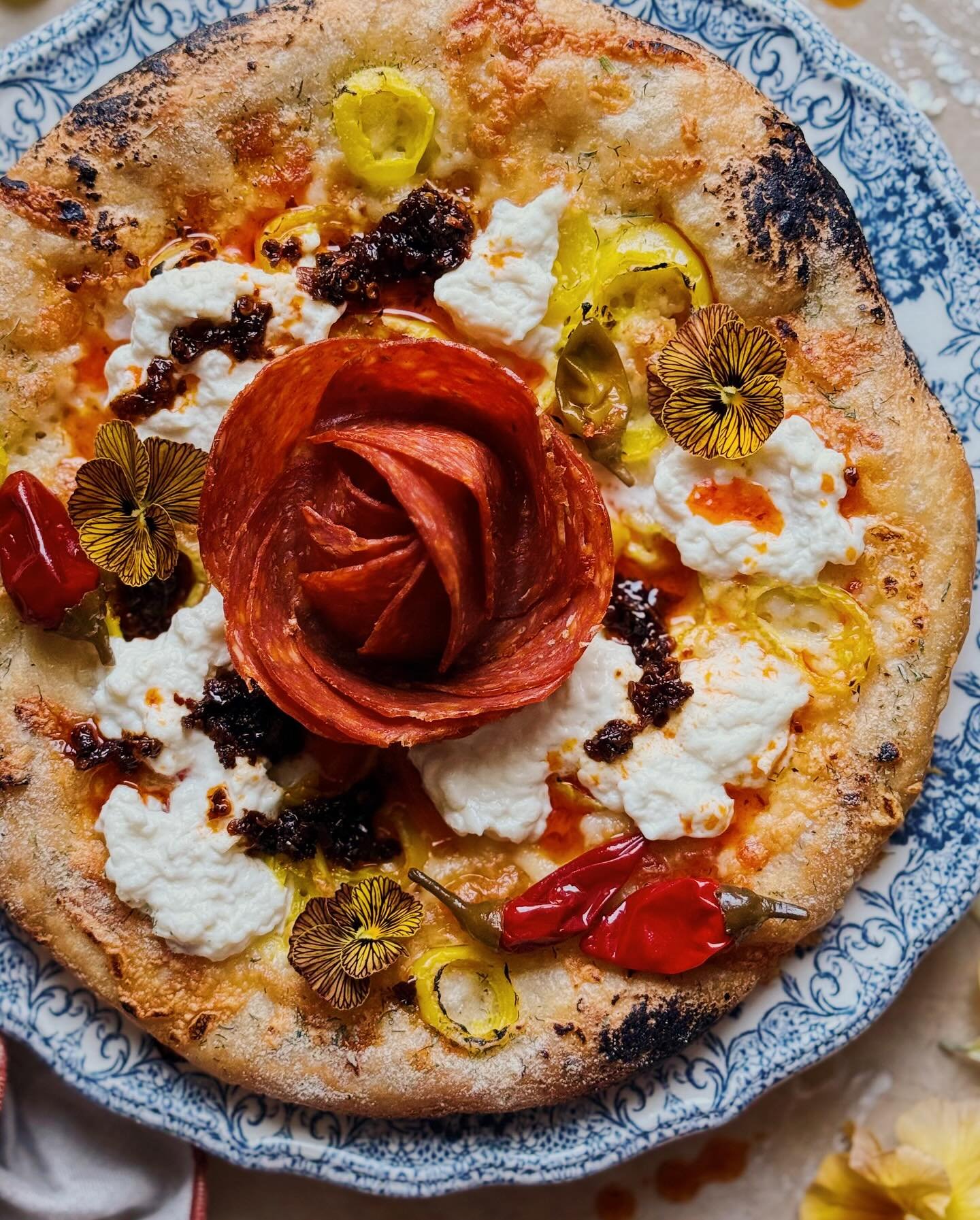 Pickled banana pepper and chili oil pizza for spicy lovers&mdash;a homemade pizza baked with grated sharp cheddar and lots of briny banana pepper rings and then topped off with stracciatella cheese (basically burrata insides), chiu chow chili oil, ca