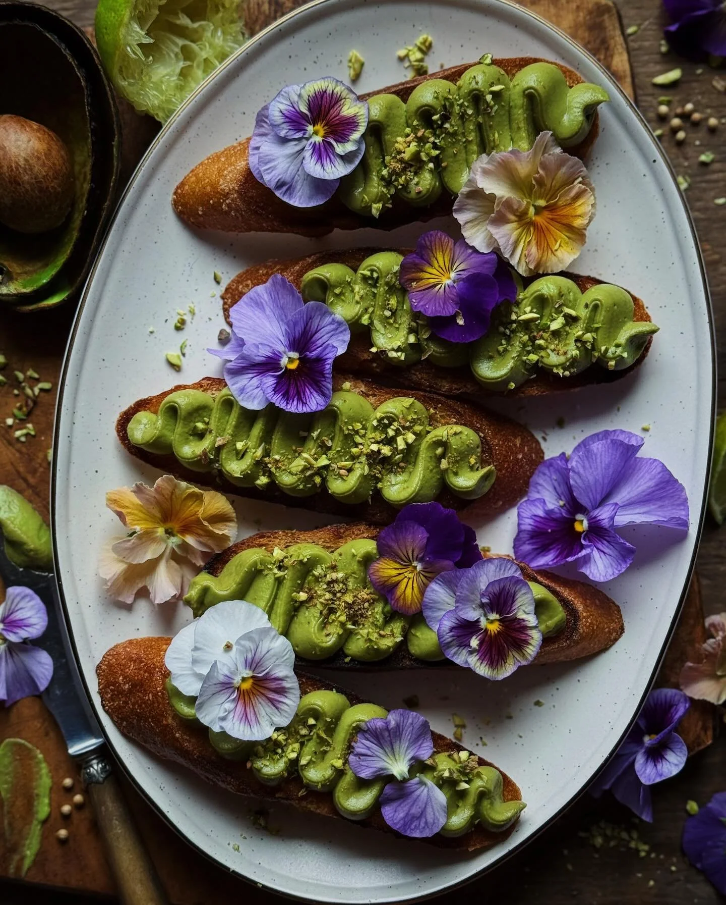 Avocado mousse crostini with pistachio dukkah (and pansies from my garden for some fun color pops).⁣
⁣
This lime-y avocado mousse is maybe the easiest way to up your avocado toast game. I used about 1.5 avocados and the juice of half a lime and a pin