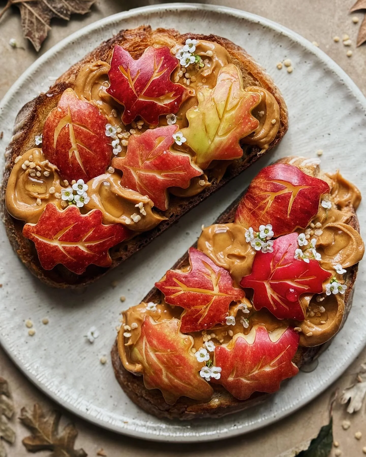 Peanut butter and apples on toast with puffed quinoa and a drizzle of chipotle honey. 
Fall isn’t my favorite fruit season but I’m trying to embrace the beauty of apples with this classic combo of apples and peanut butter that reminds