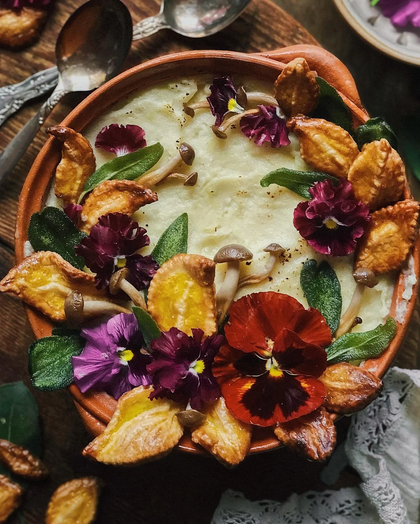 Shepherd’s pie meets moussaka in this cozy thick stew of spiced lamb, eggplant, and tomato sauce topped with a layer of mashed potatoes. I decorated with leaves made of leftover pie crust, fried sage, fried shimeji mushrooms, and violas. 
I