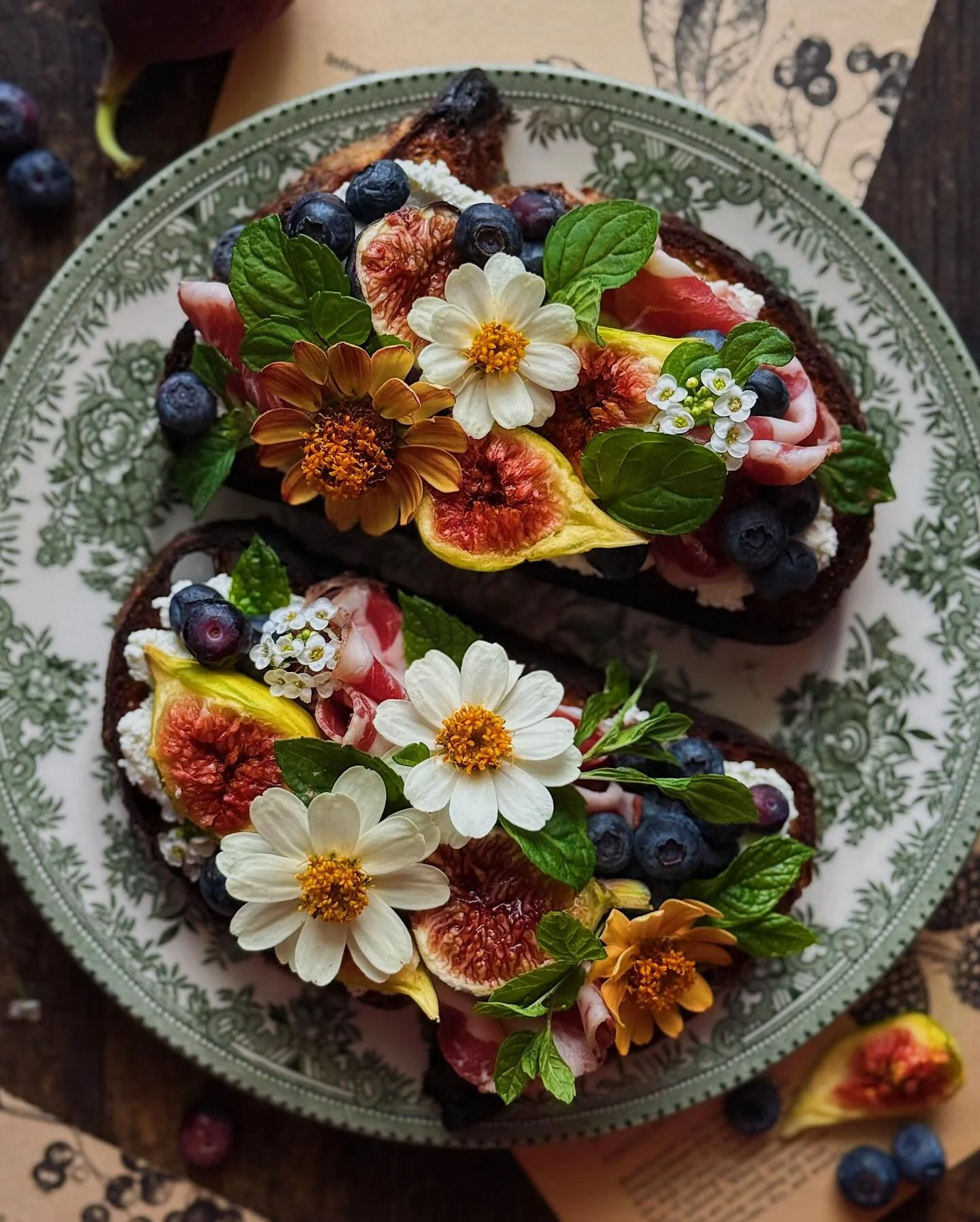 Savoring the last moments of fig season with these sweet and savory toasts. These are country bread slices pan-fried in olive oil and topped with soft ch&egrave;vre/goat cheese, figs, coppa, blueberries, and garden-grown mint. The flowers are zinnias