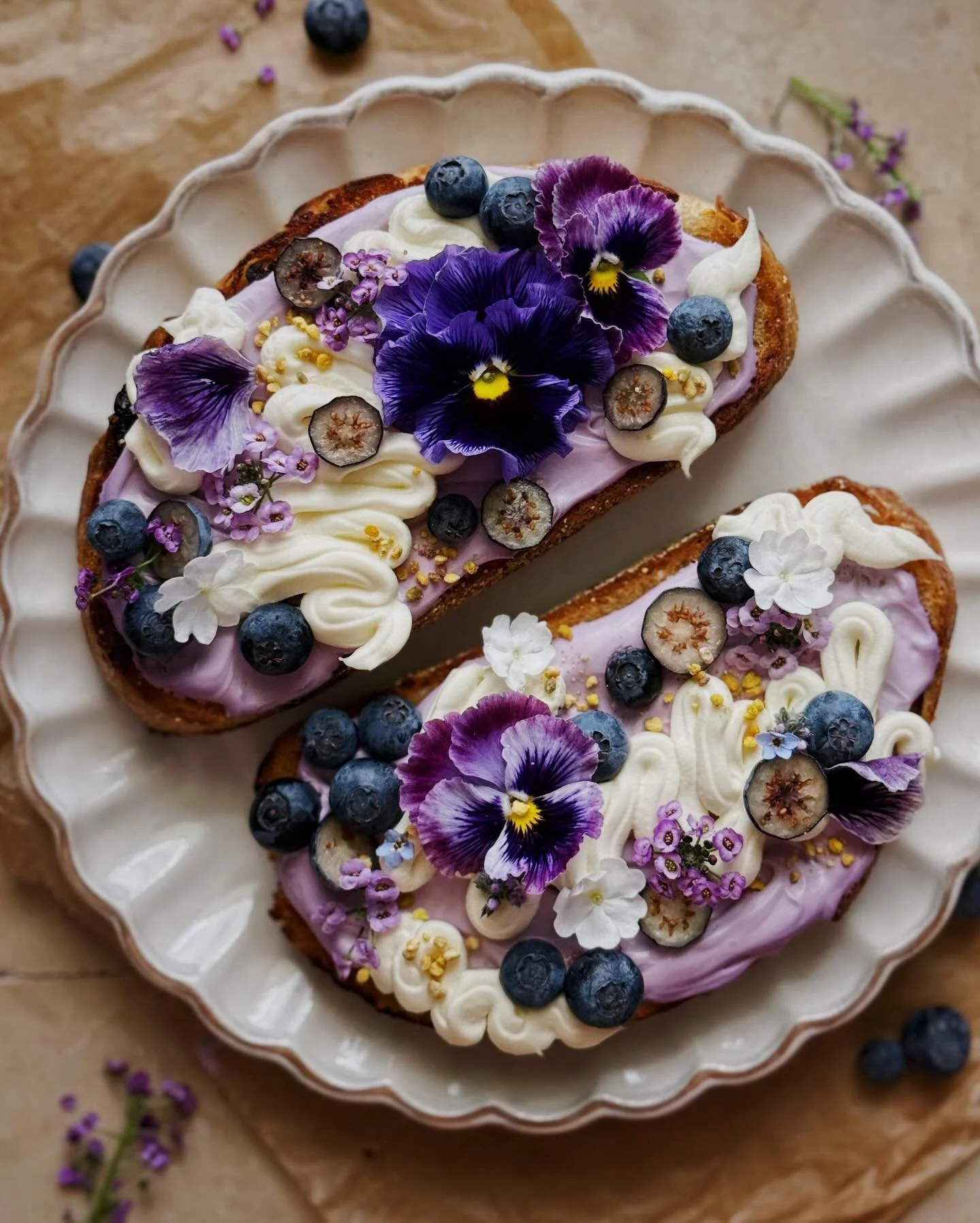 Blueberries and cream toasts. &thinsp;
&thinsp;
You know I rarely make anything that is fully sweet or desserty so these toasts started out with a very savory black garlic and asiago bread that I got at the farmers market. The lilac colored spread is