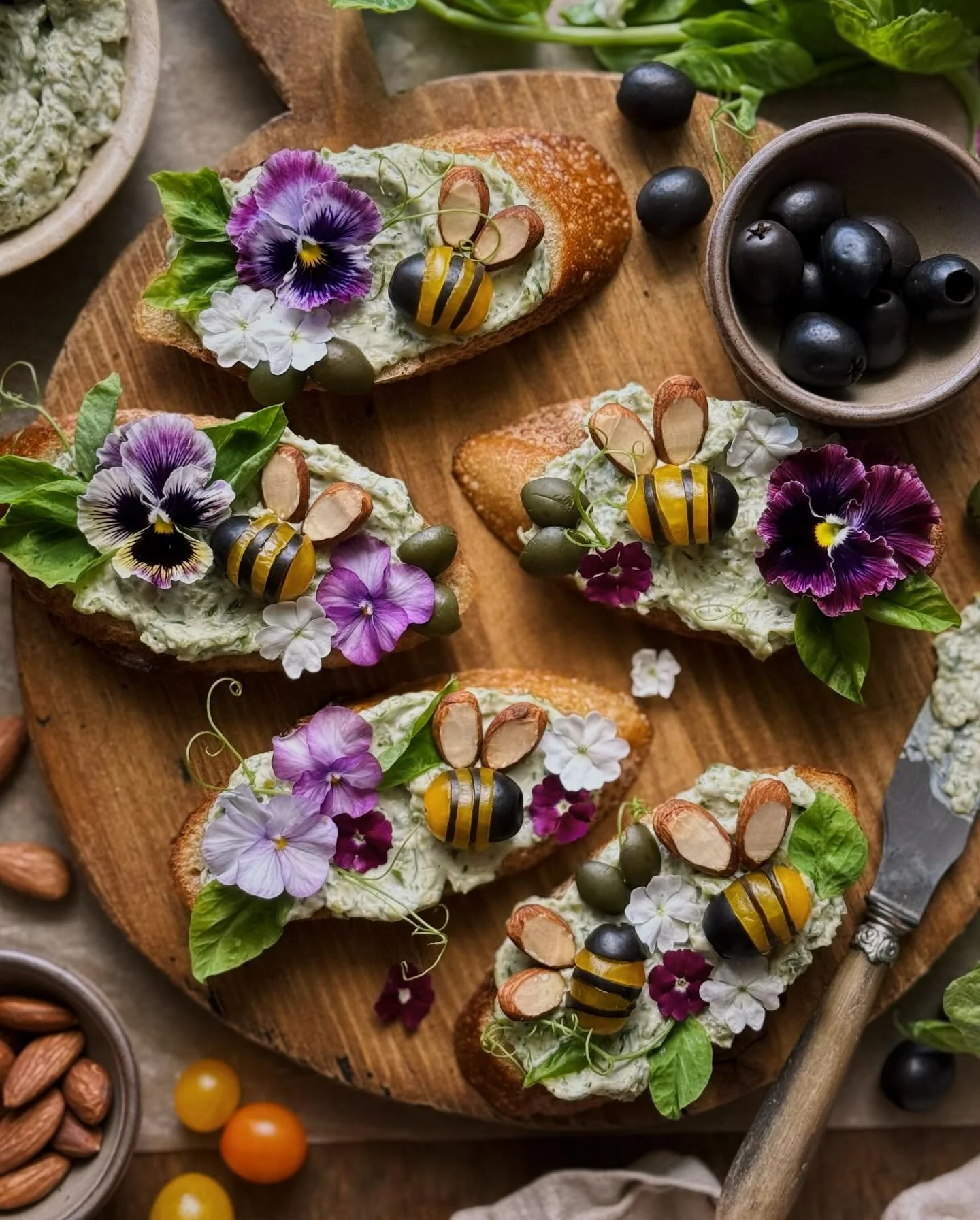 These green ripe olive and gorgonzola crostini&mdash;adorned with little edible bumblebees made of black ripe olives, tomatoes, and almonds&mdash;are my whimsical way to enjoy both green and black @calripeolives this spring. [AD] &thinsp;
&thinsp;
Mi