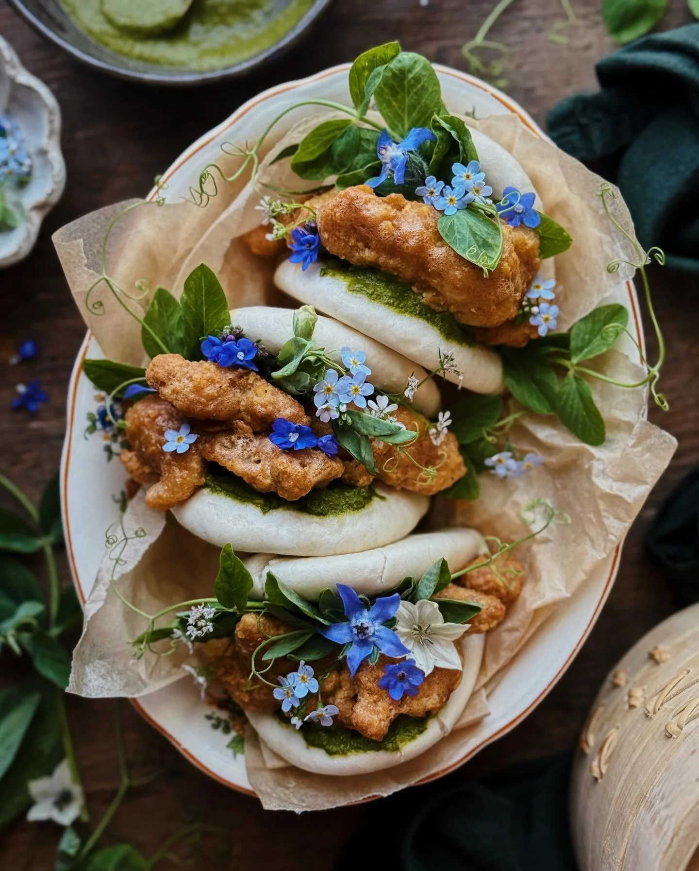 Salted egg yolk fried chicken bao&mdash;a freezer/fridge cleanout weeknight meal of fluffy steamed buns stuffed with crispy savory chicken, an herby mayo, fresh spring pea greens, and edible flowers.&thinsp;
&thinsp;
I made these bao, in particular, 