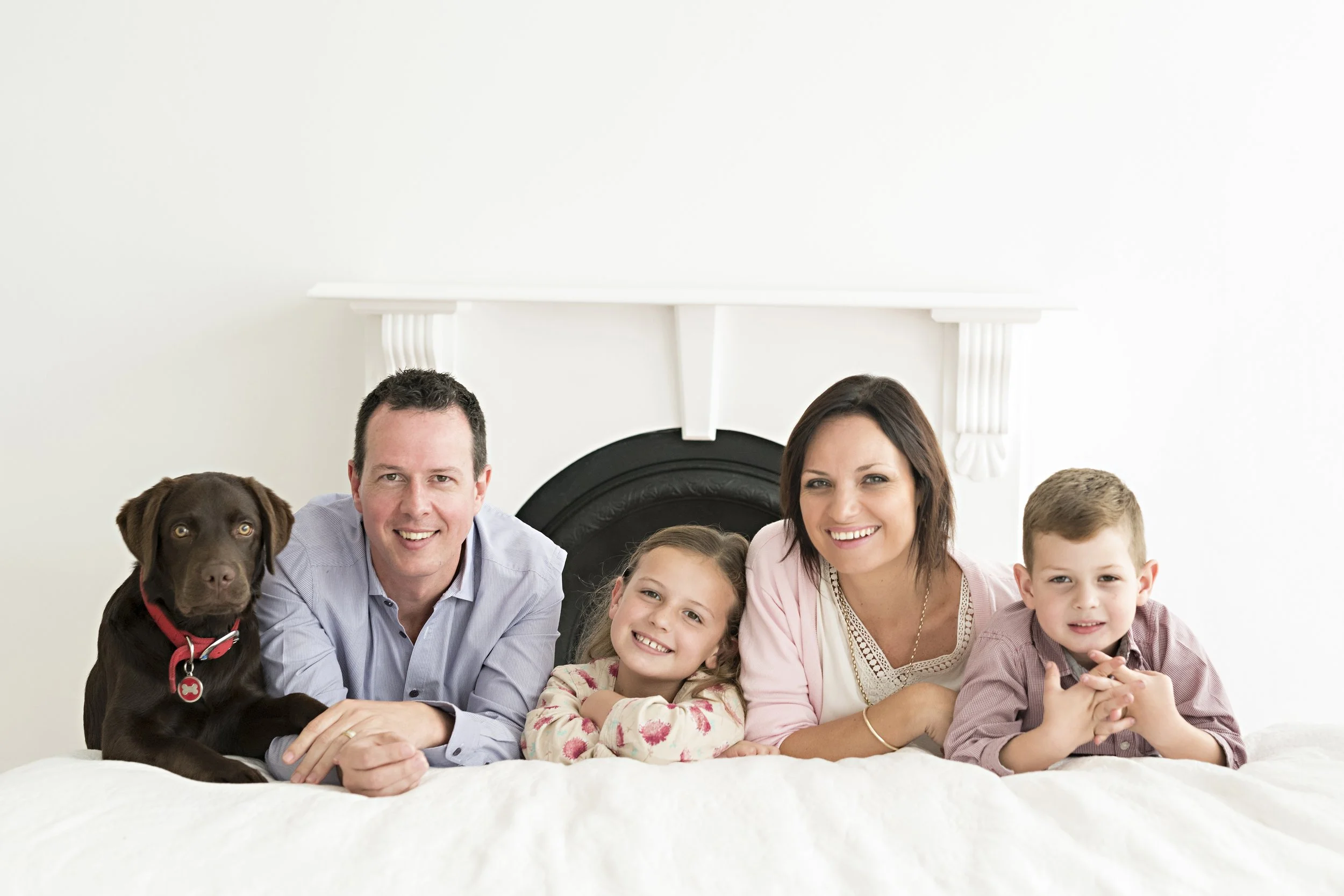 Mum, dad, two kids and their chocolate labrador together in a Sydney North Shore family studio photography session